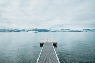 a long dock sitting in the middle of a body of water