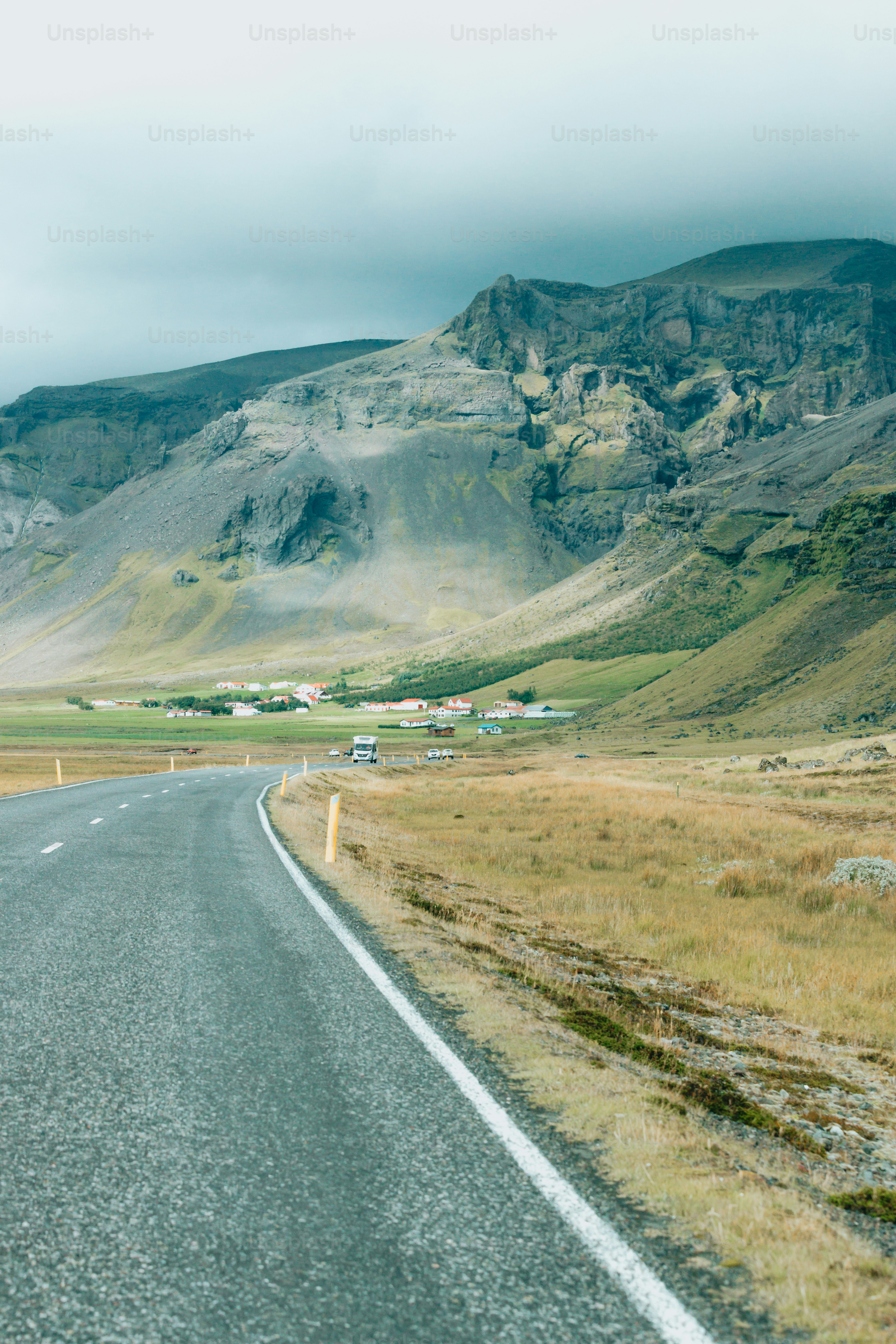 a long road with a mountain in the background