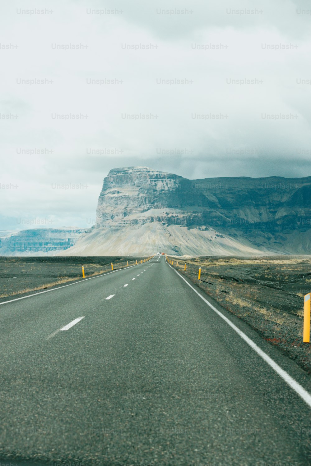 a road with a mountain in the background