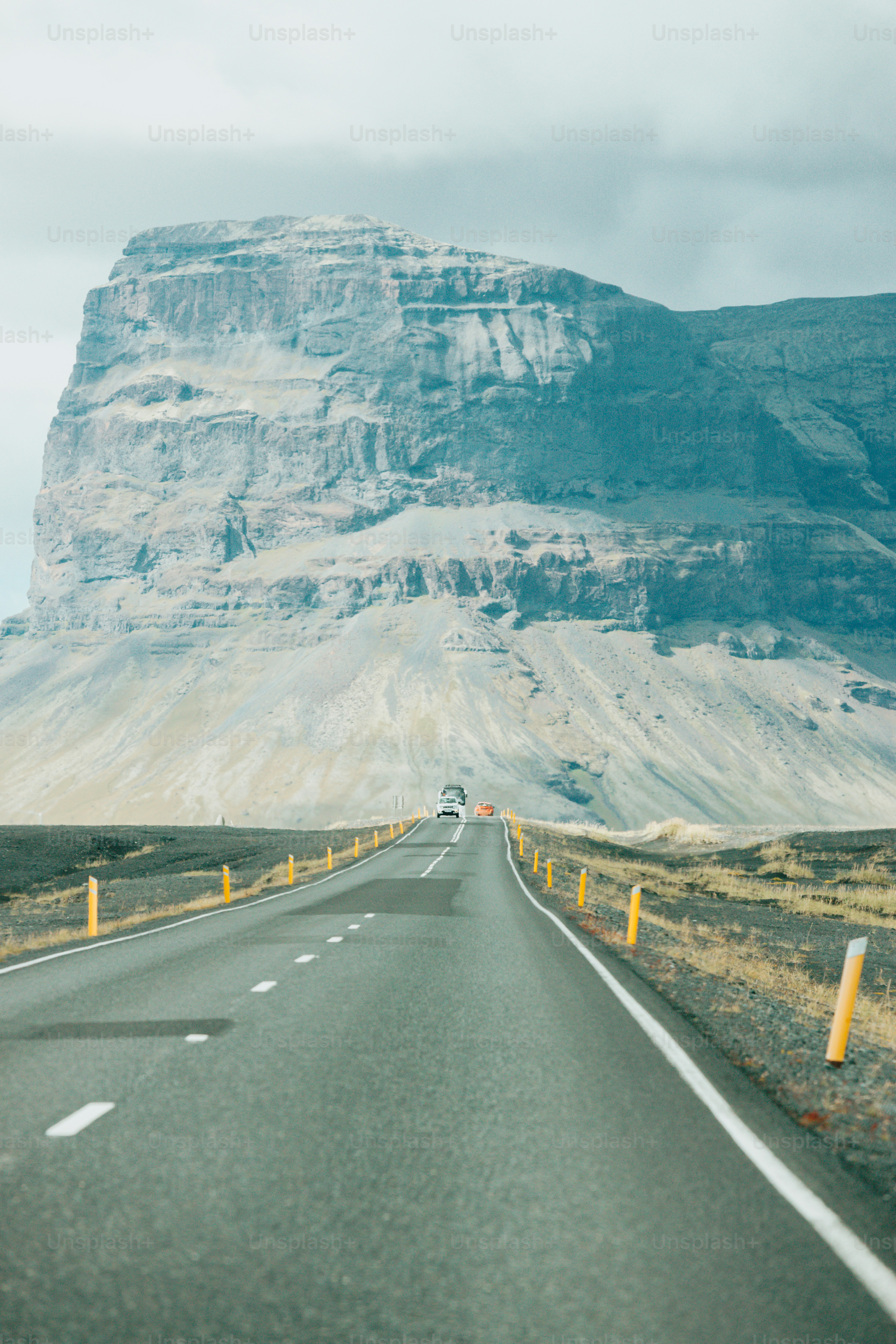 a long road with a mountain in the background