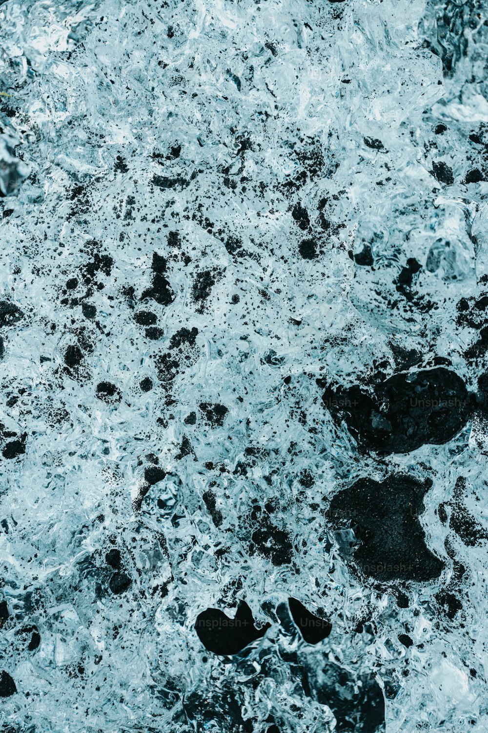 a black and white photo of water and rocks