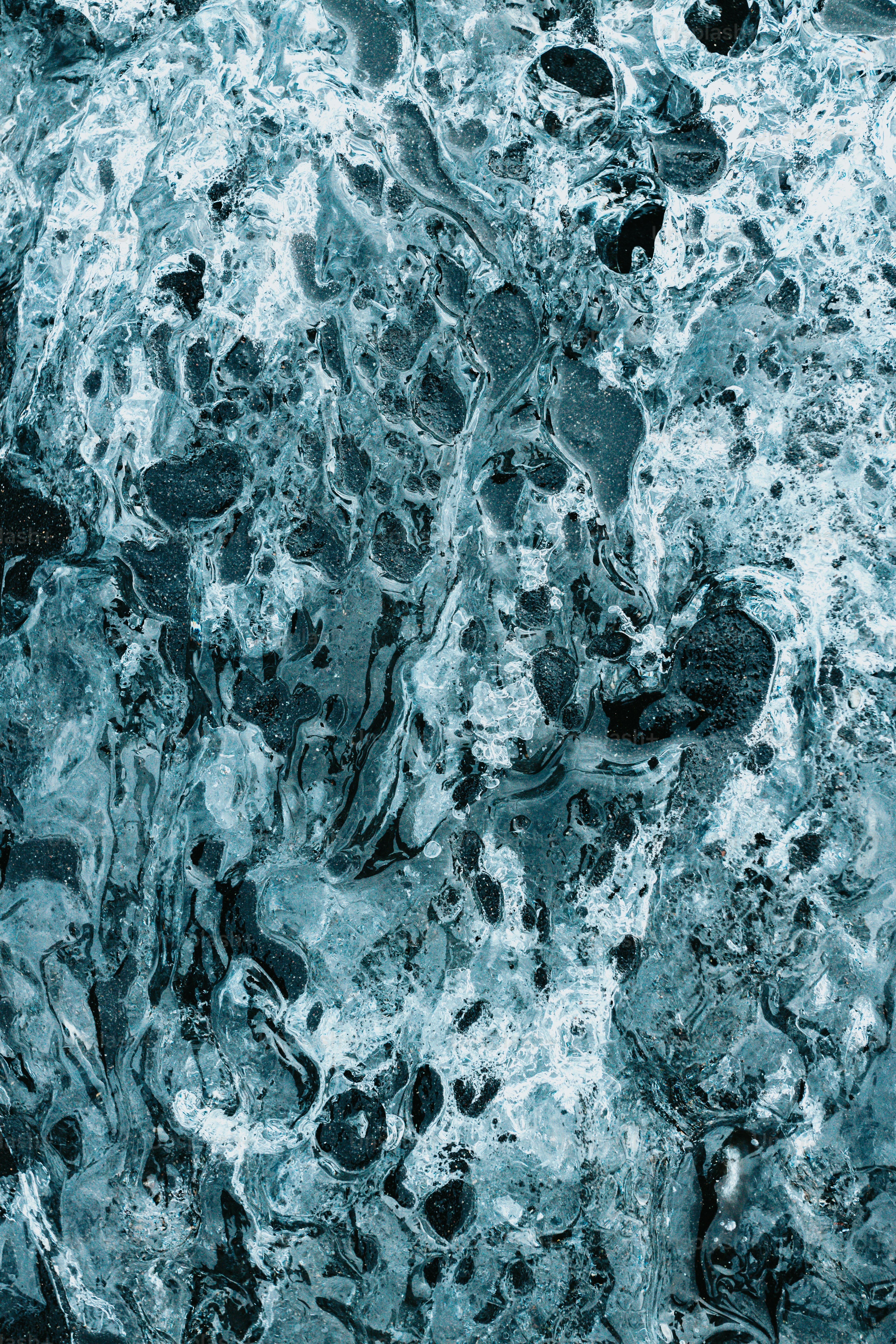 a black and white photo of water and rocks