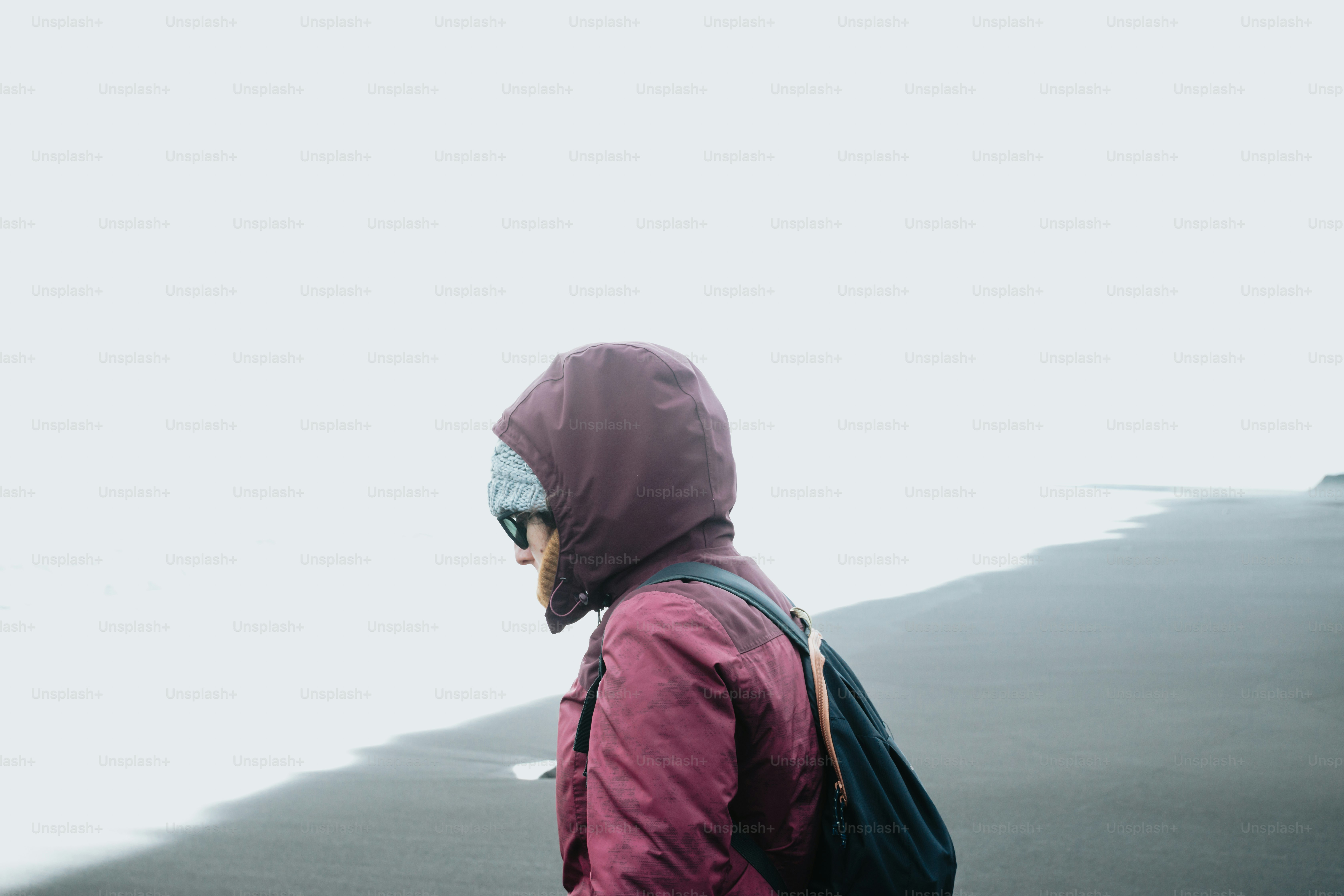 a person with a backpack walking on a beach