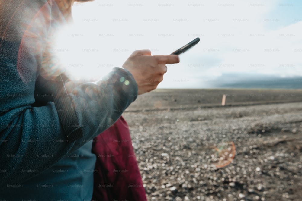 a person holding a cell phone in their hand