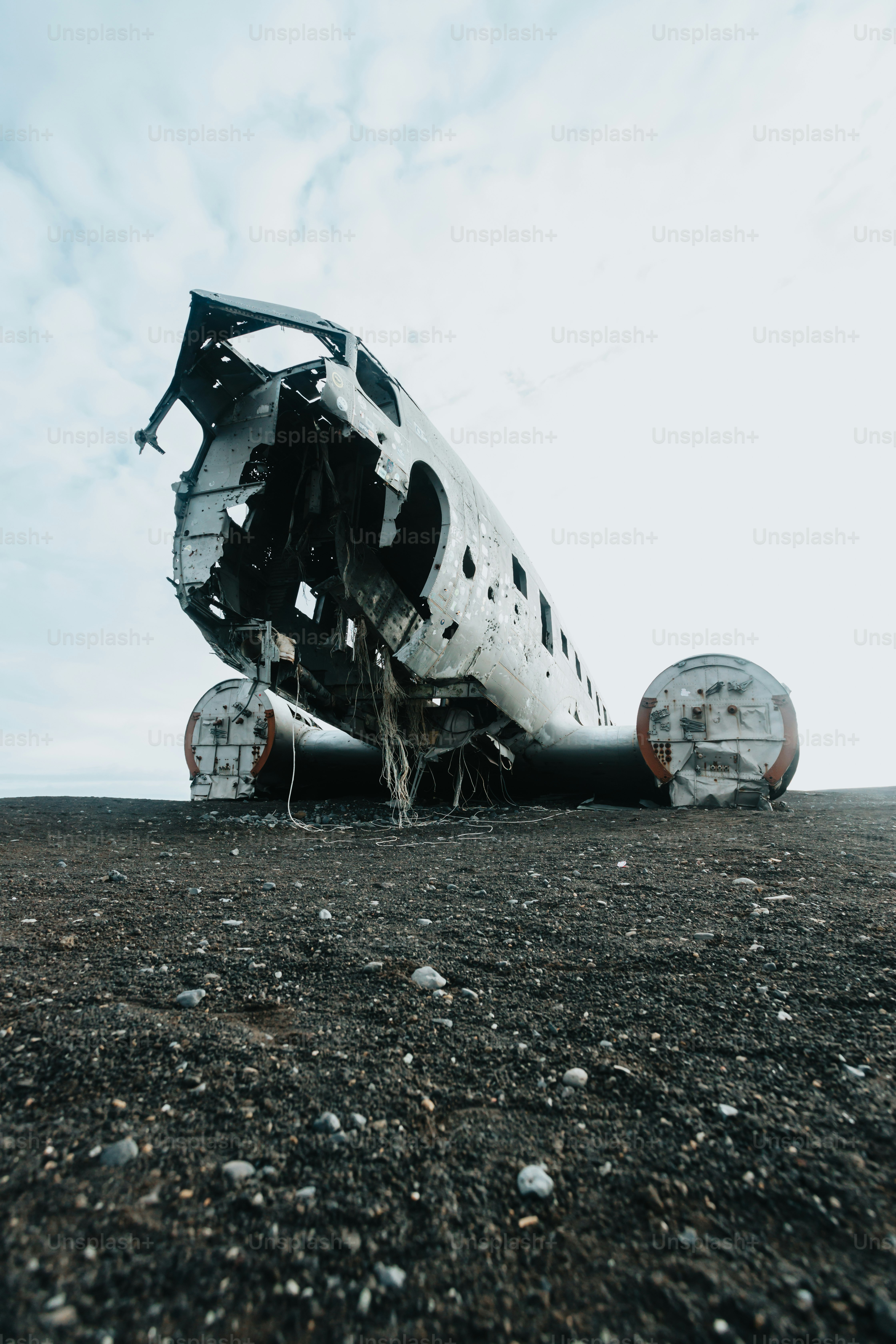 a plane sitting on top of a dirt field