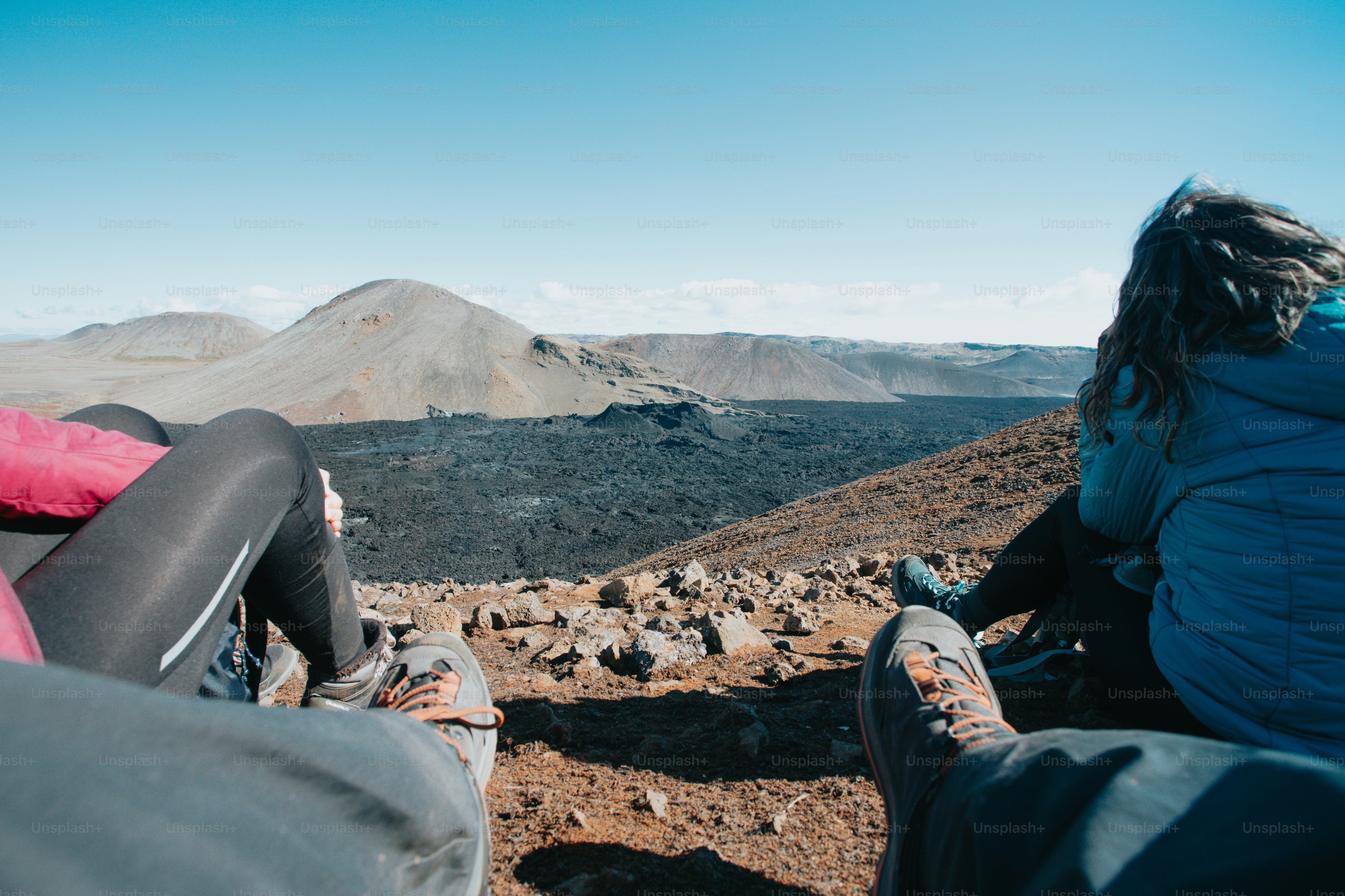 A couple of people sitting on top of a mountain photo – Nature Image on ...