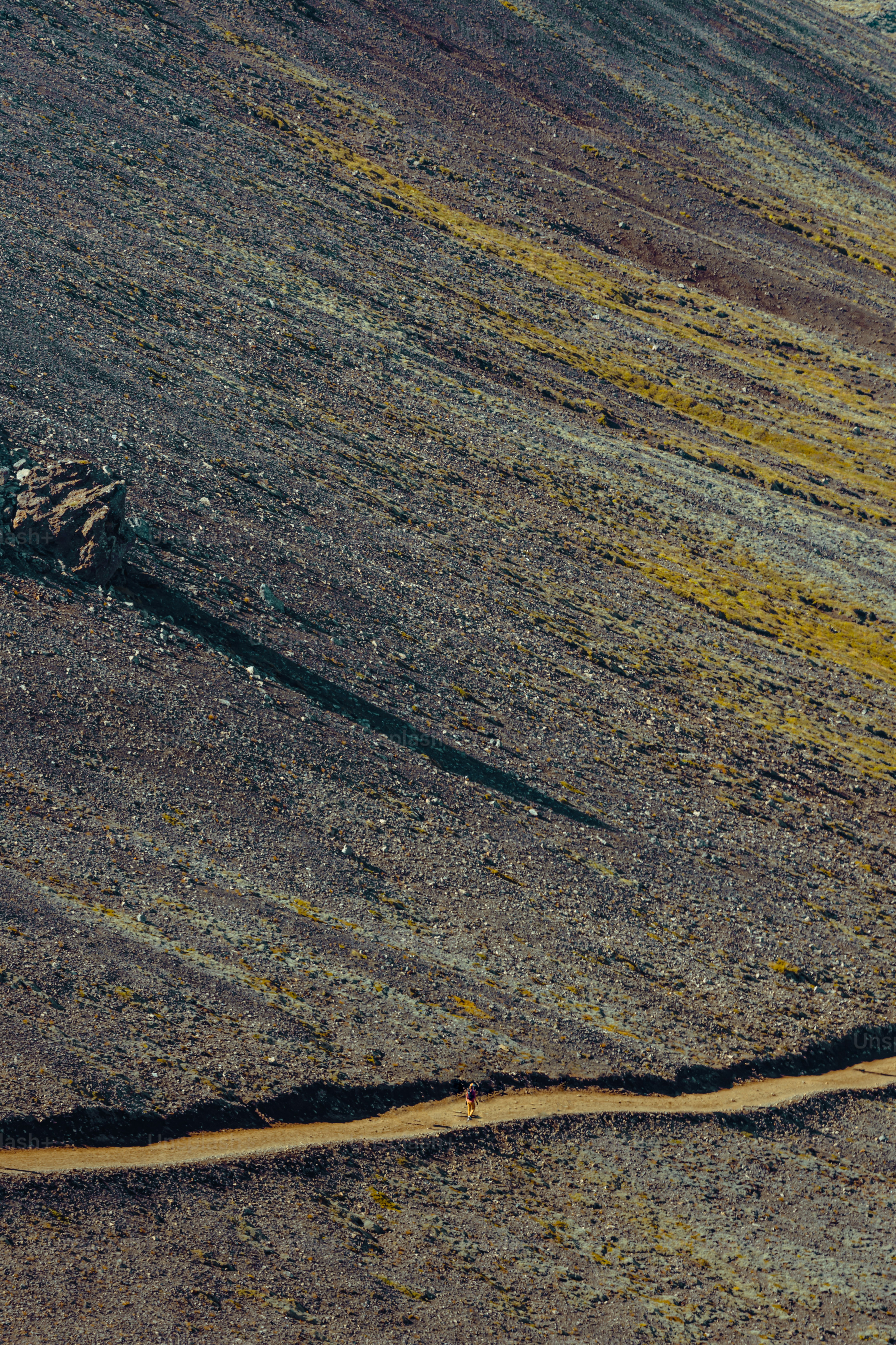 a person riding a motorcycle down a dirt road