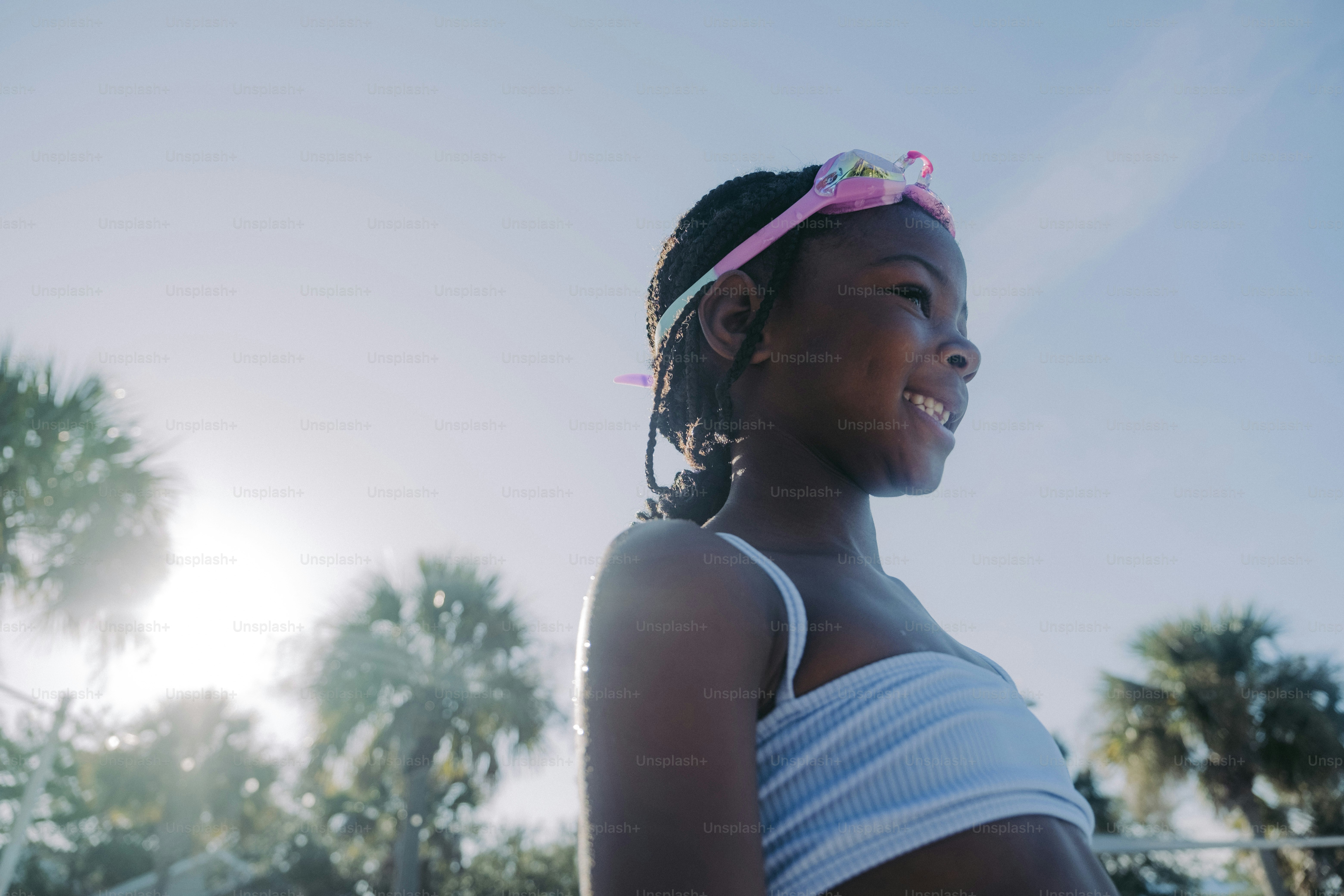 a young girl with a pink bow on her head