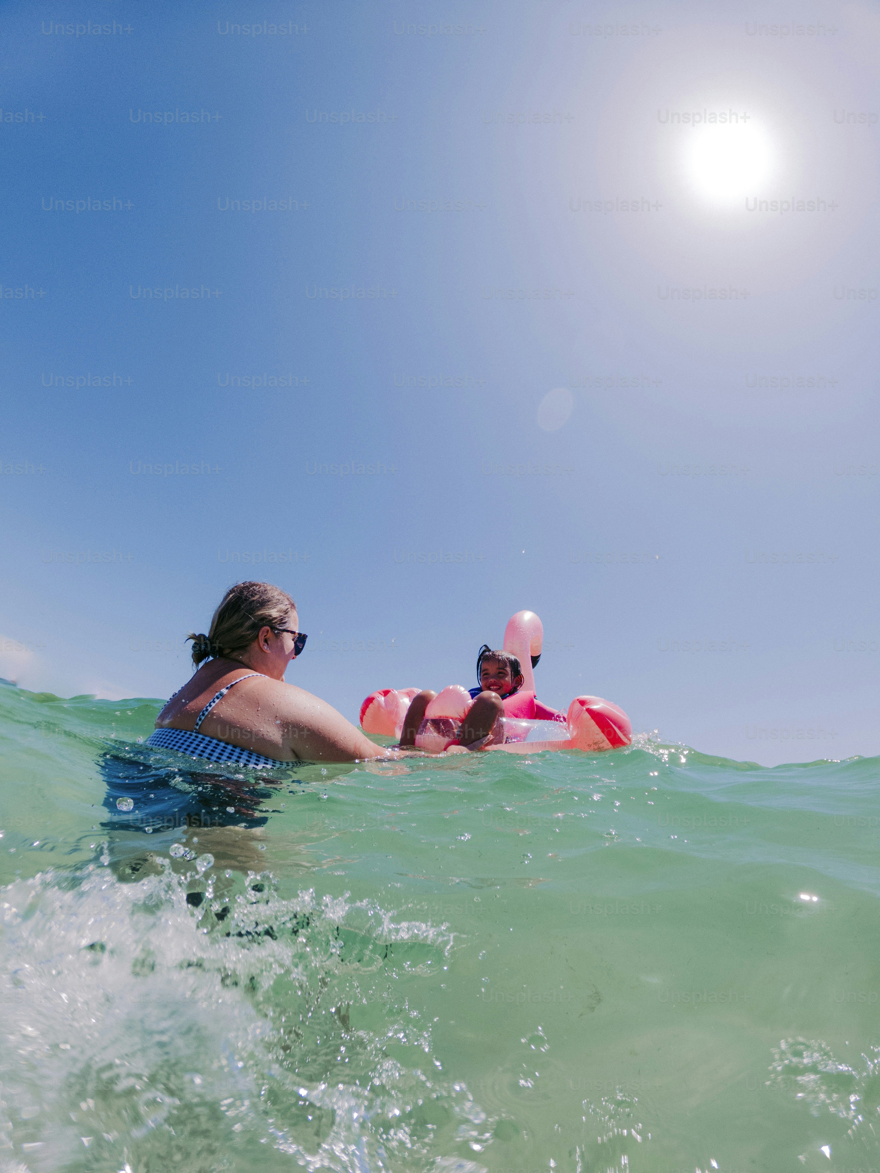 a woman and a child are in the water