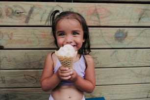 a little girl eating an ice cream cone