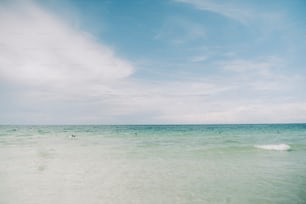 a person riding a surfboard on top of a wave in the ocean