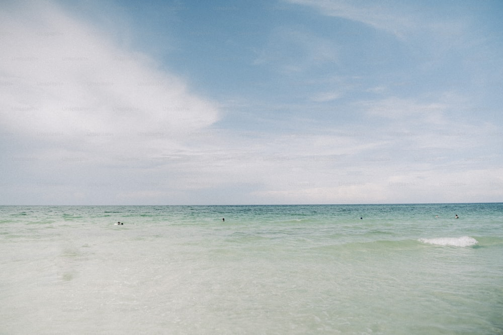 a person riding a surfboard on top of a wave in the ocean