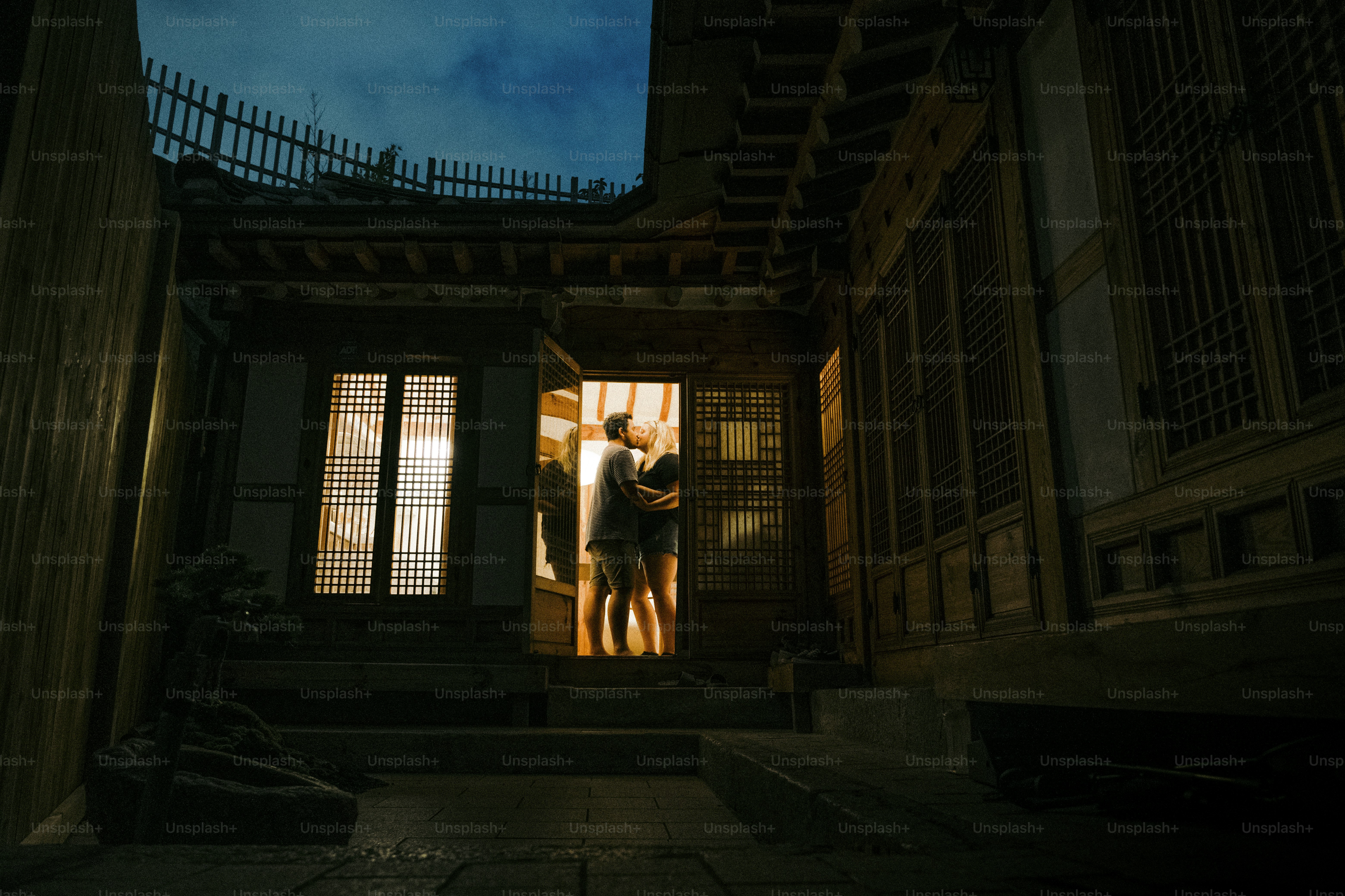 a couple of people standing outside of a building