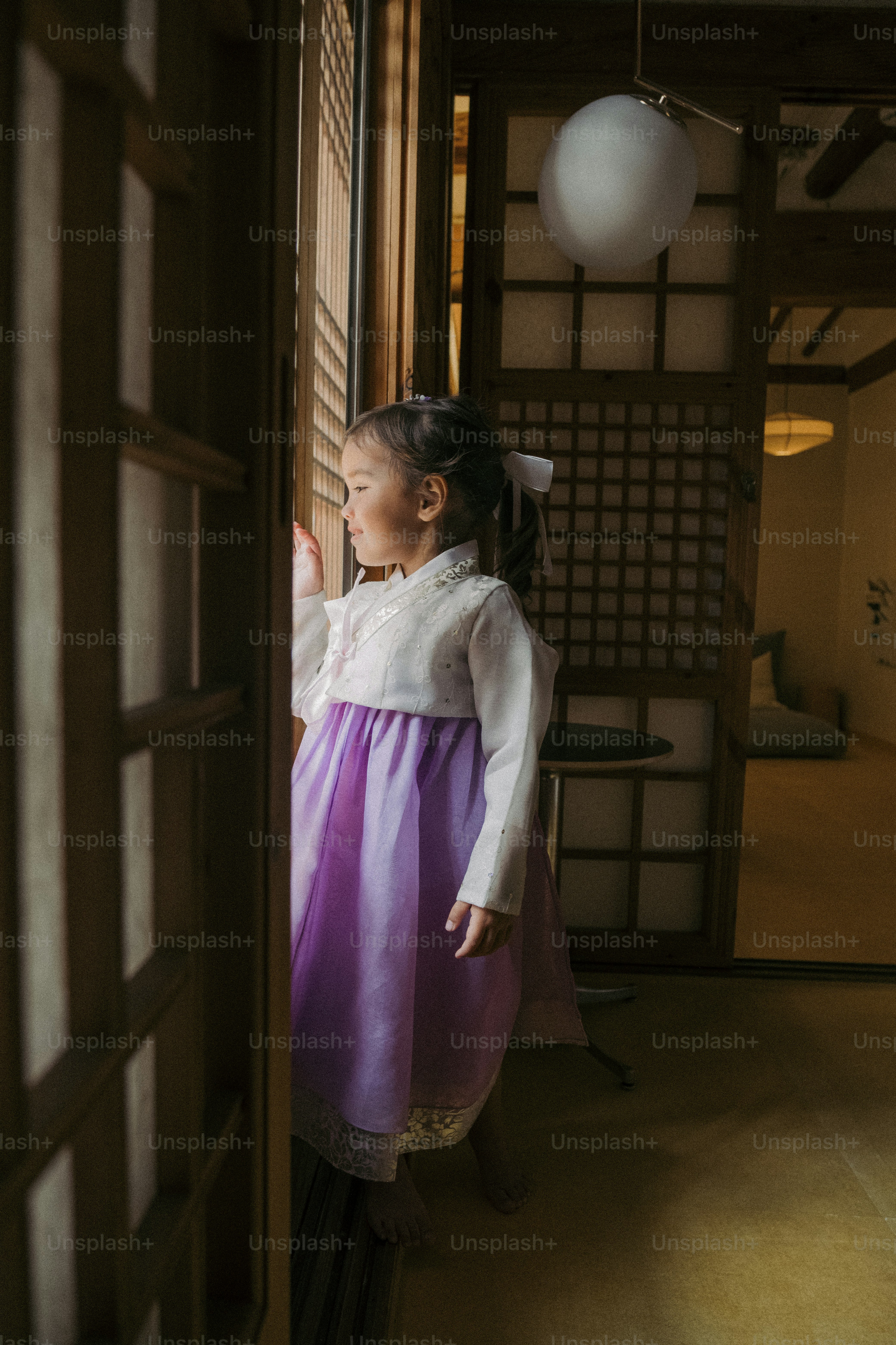 A little girl in a blue dress standing on a sidewalk photo – Brown hair ...