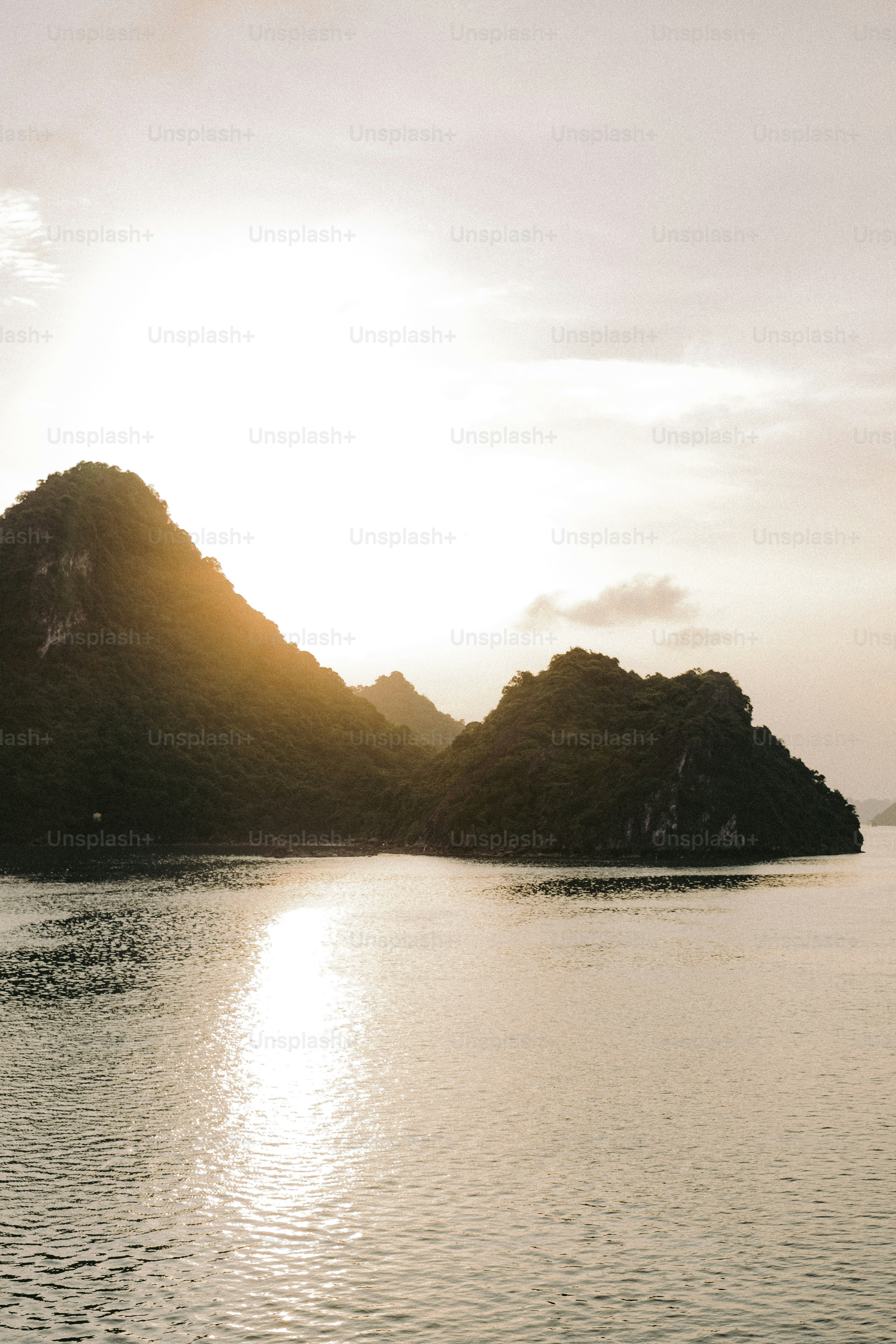a body of water with mountains in the background