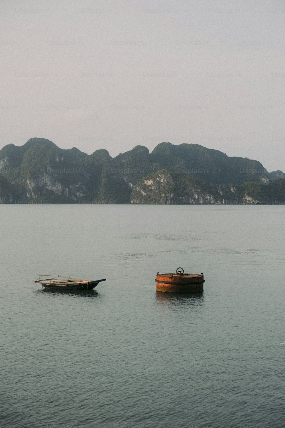 a couple of boats floating on top of a large body of water