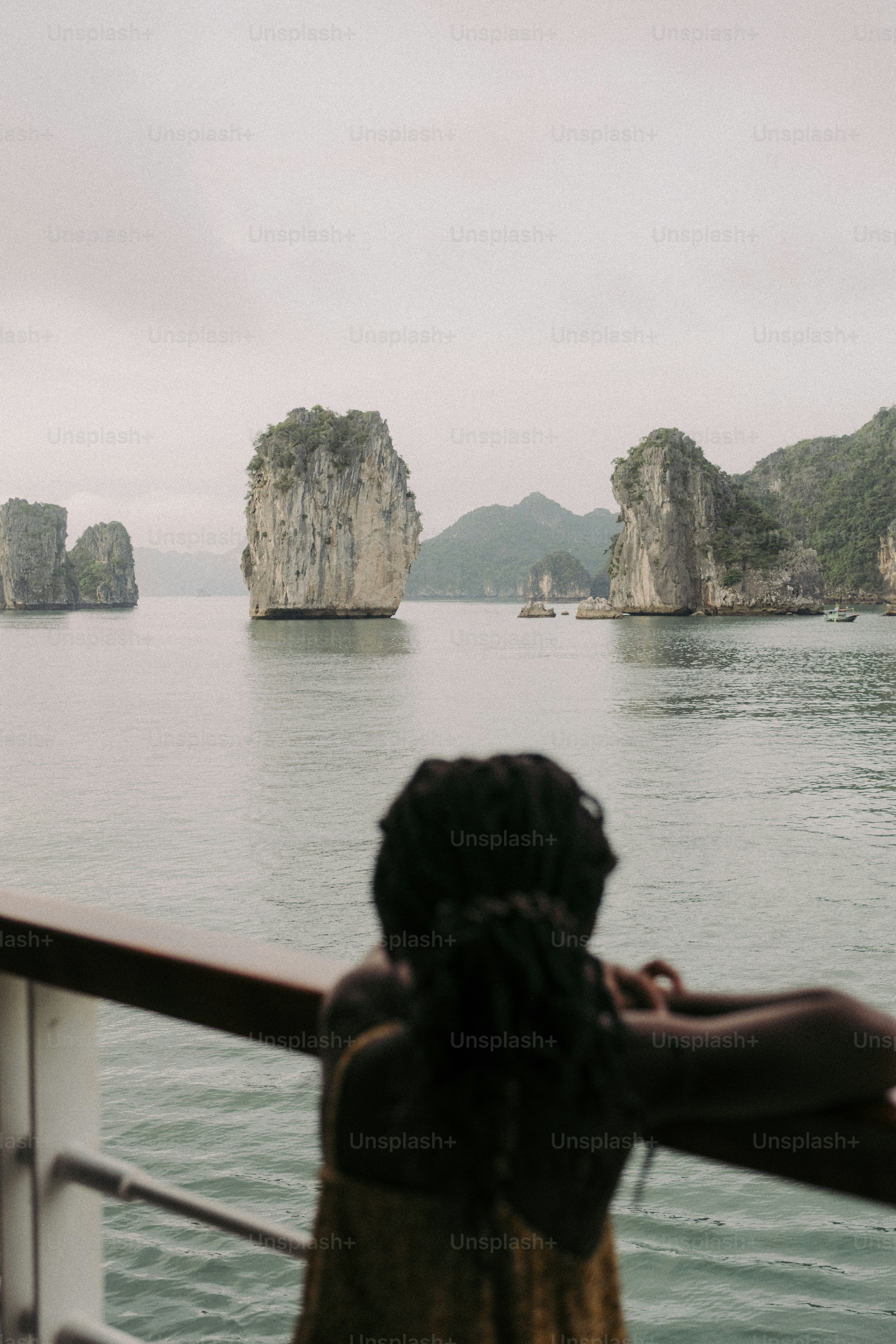 a woman looking out over a body of water