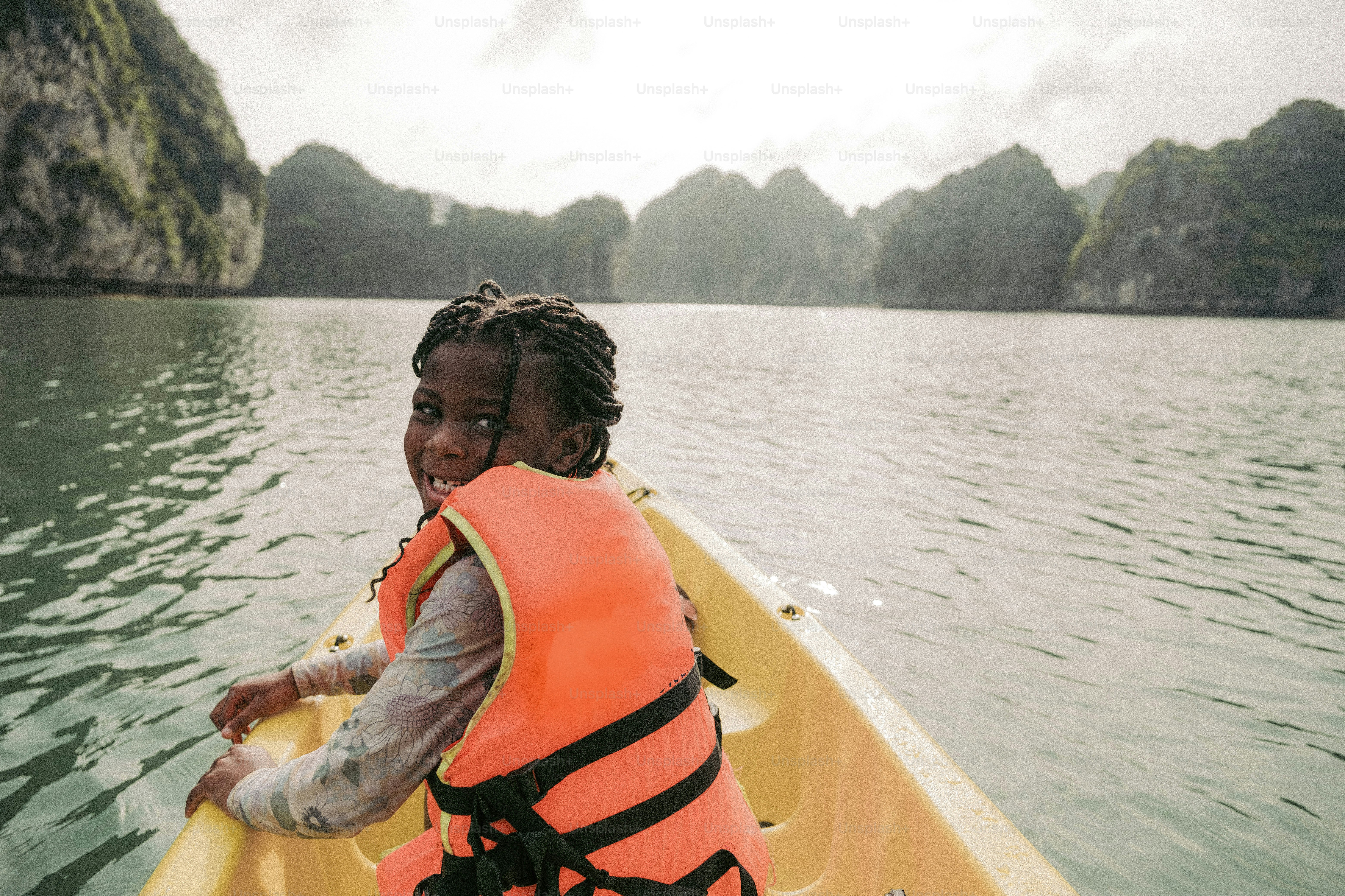 two children in a boat on a body of water