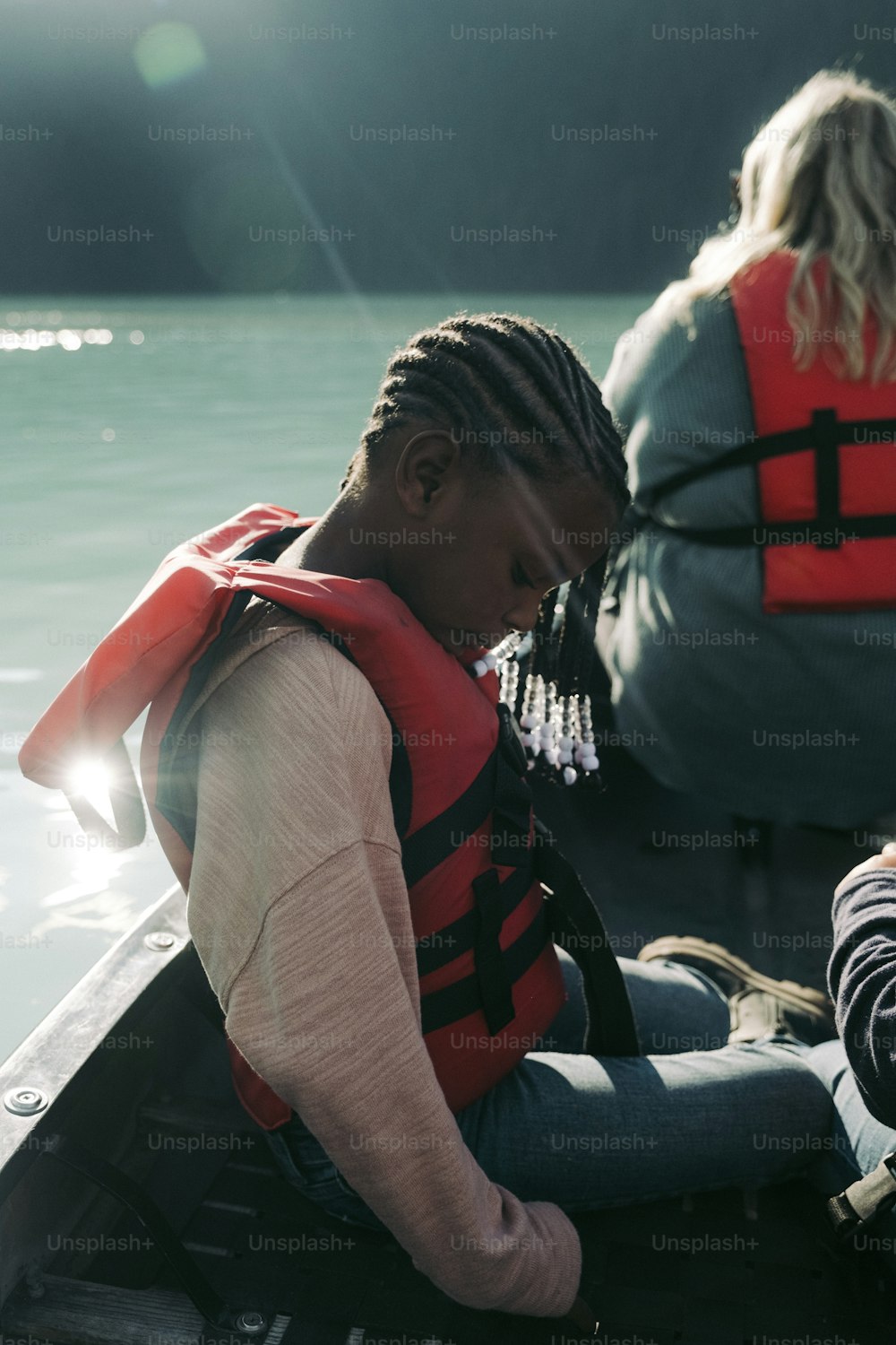 a woman in a life jacket sitting in a boat