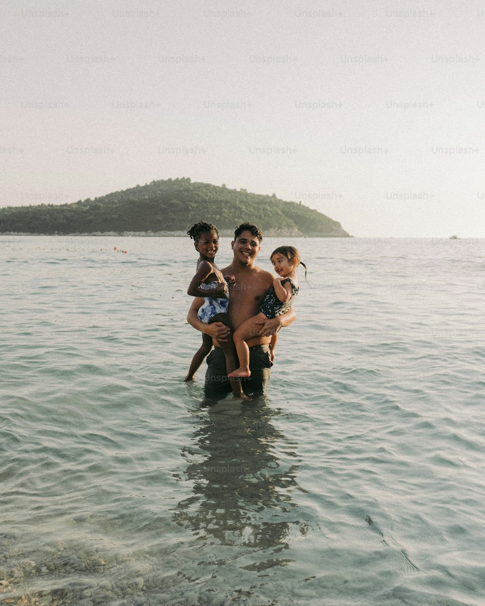 a group of people standing in a body of water