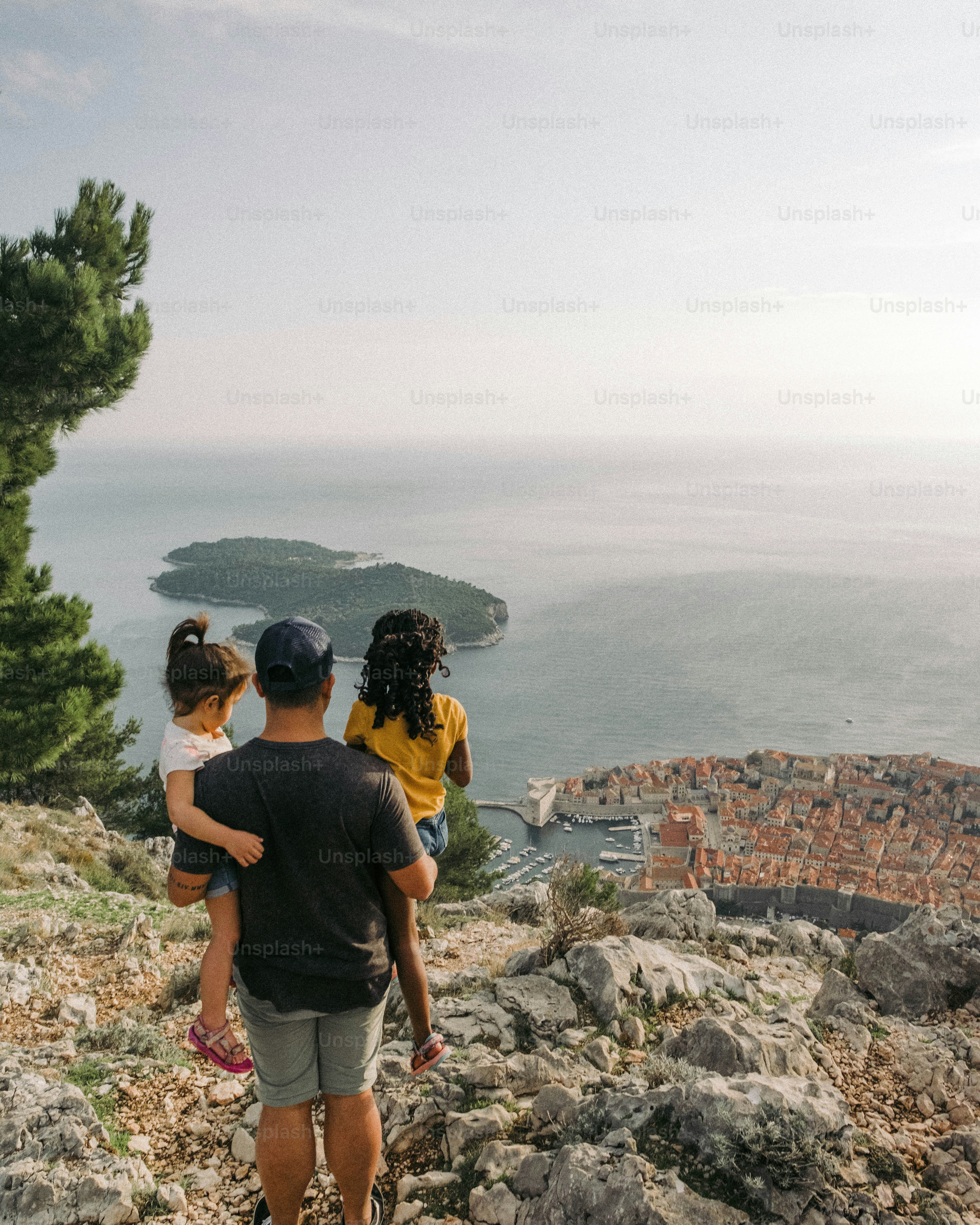 A couple of people that are standing on a hill photo – Family Image on ...