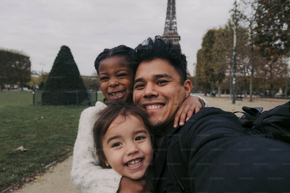 a man taking a selfie with two little girls