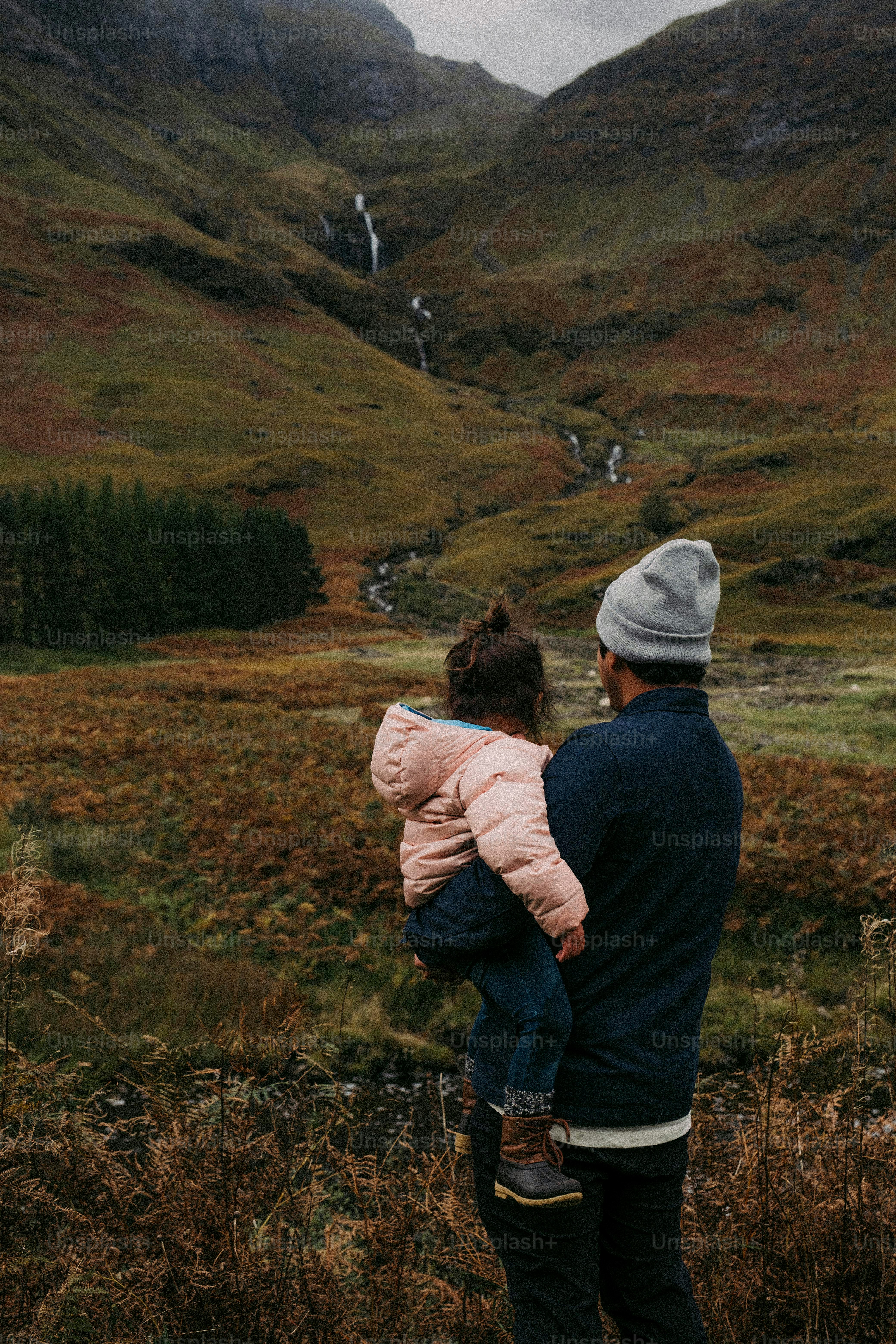 a man holding a little girl in his arms