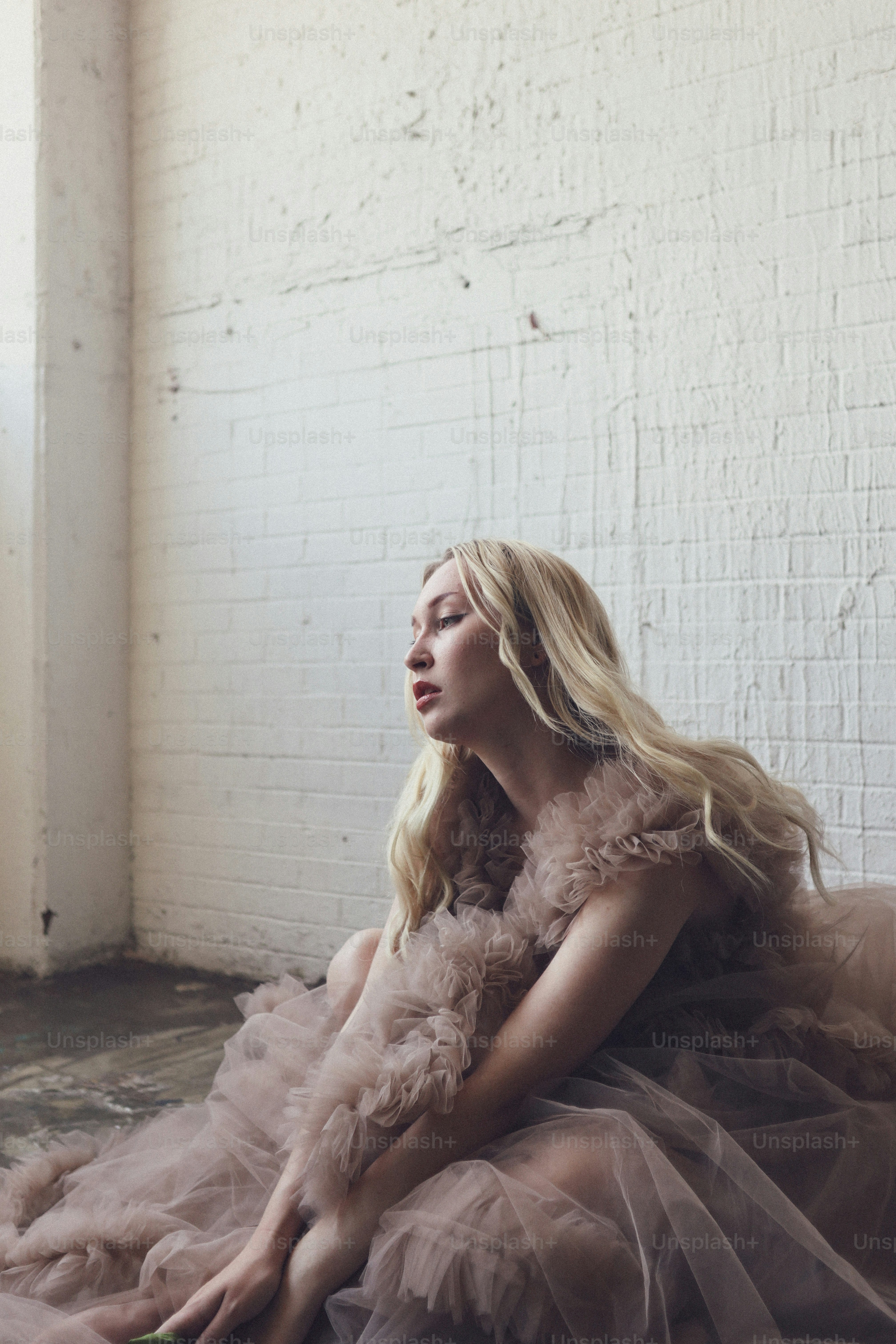 a woman in a dress sitting on the floor