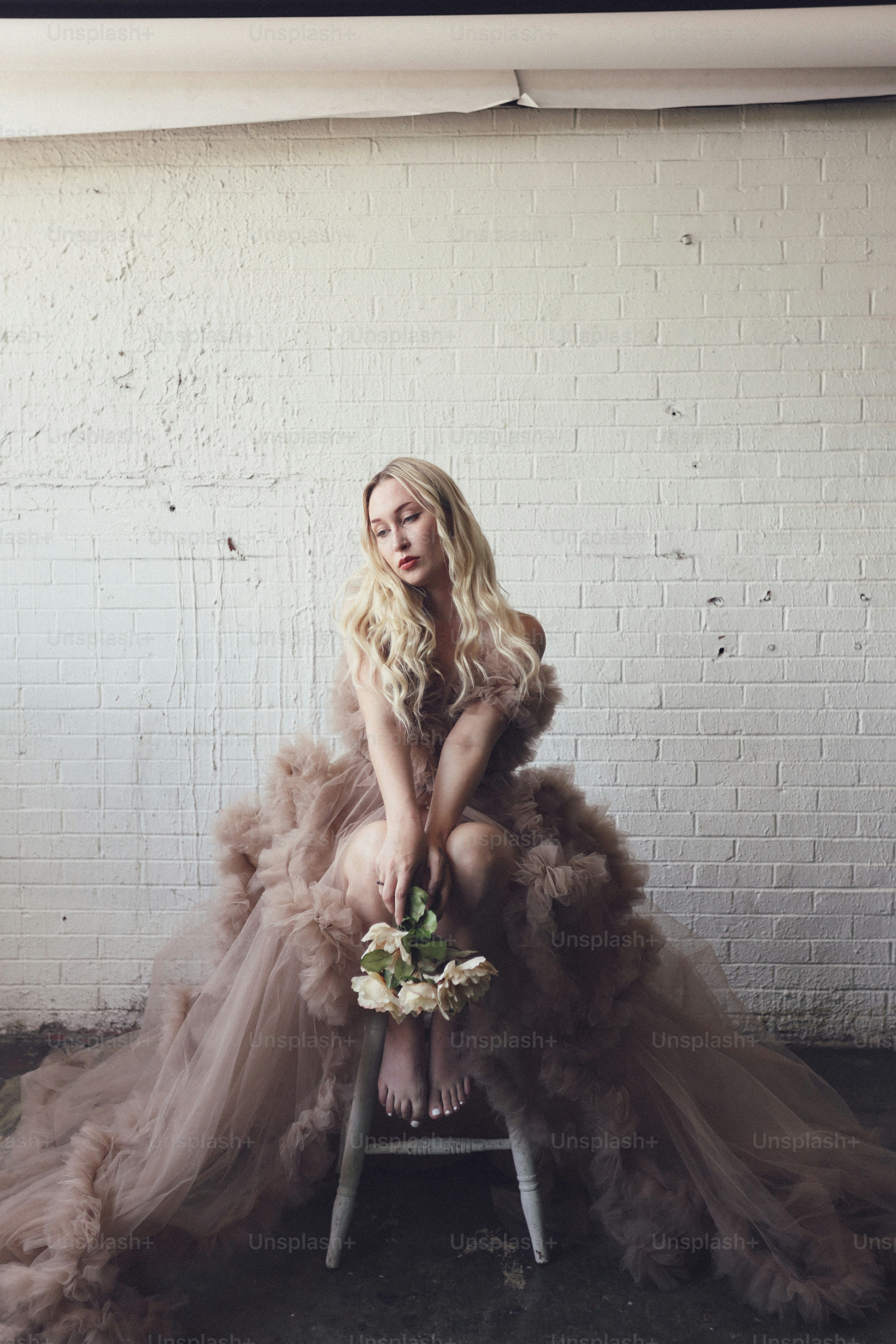 a woman sitting on top of a chair wearing a dress