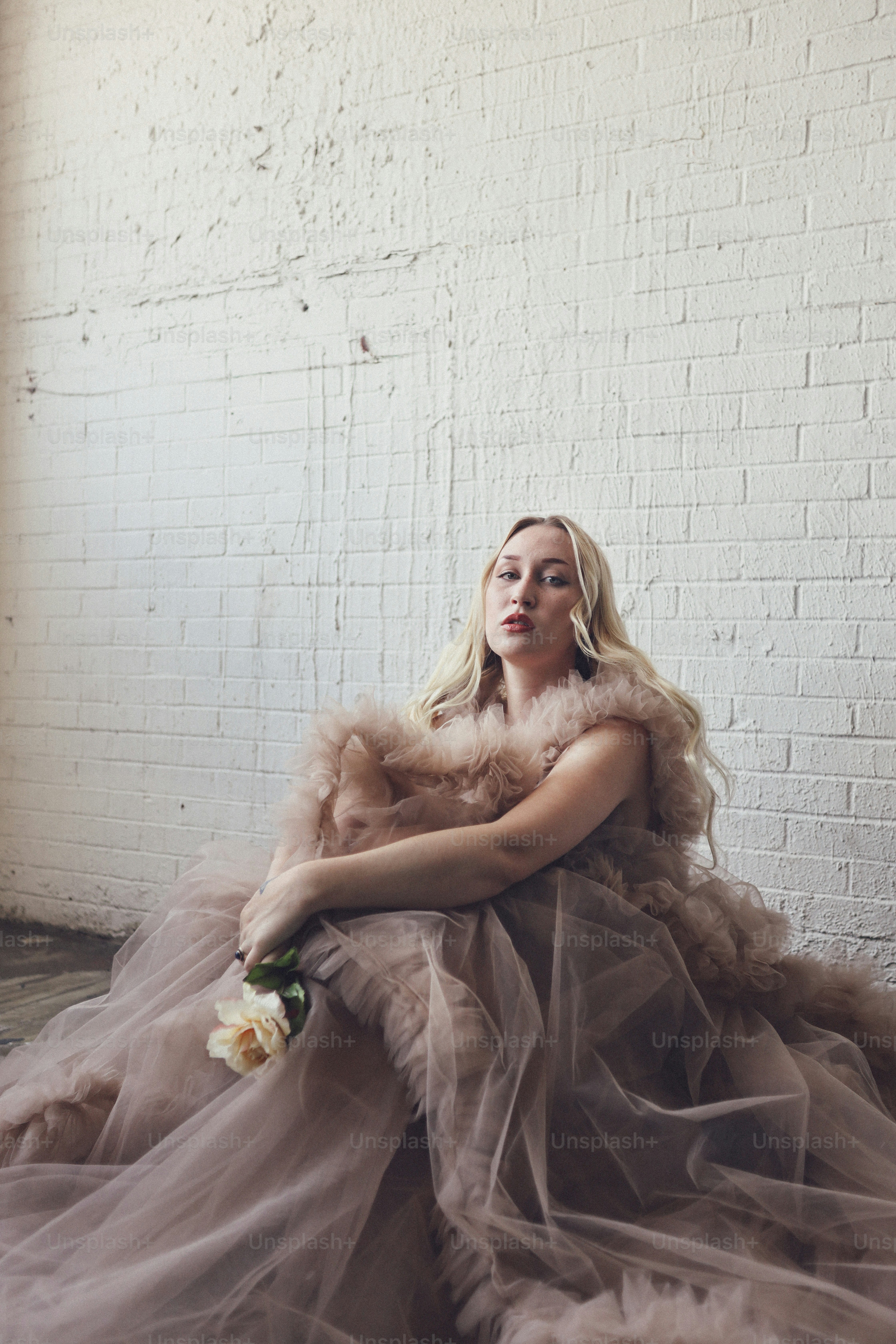a woman sitting on the floor in a dress