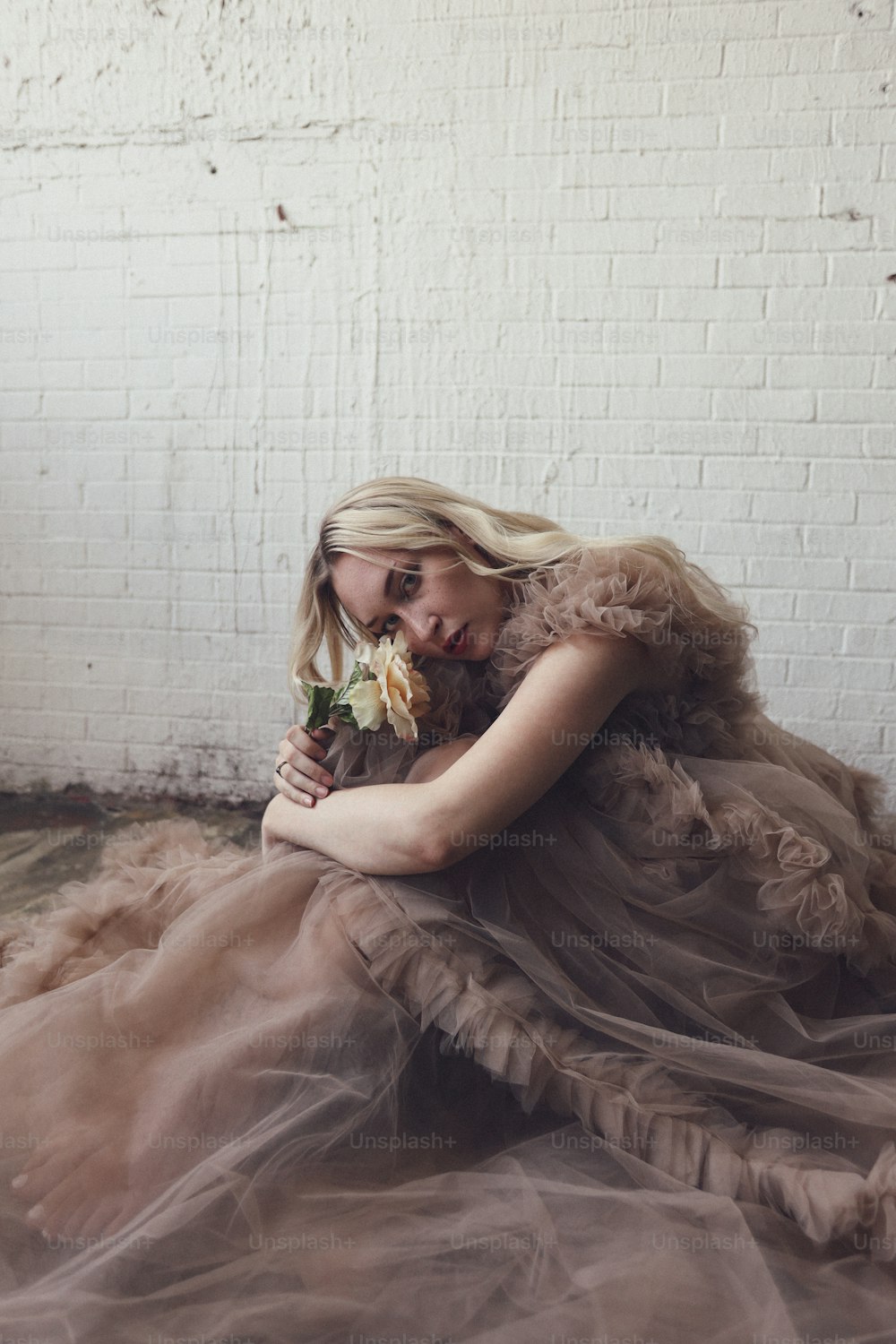 a woman in a dress sitting on the floor