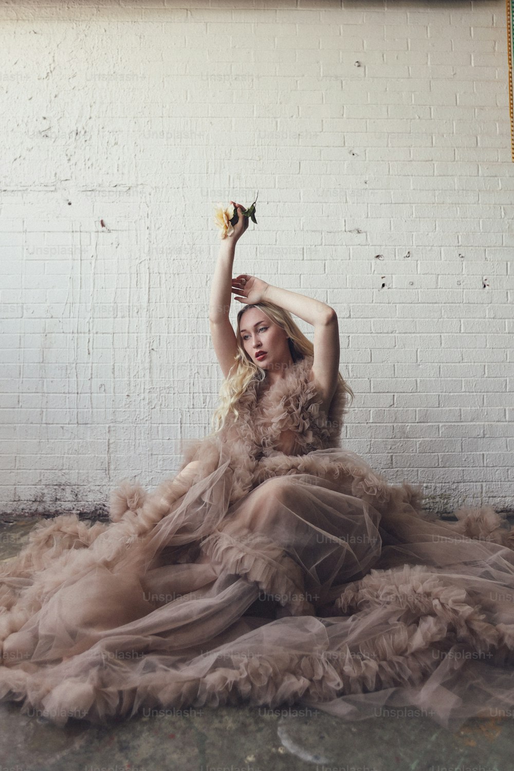 a woman in a dress sitting on the ground