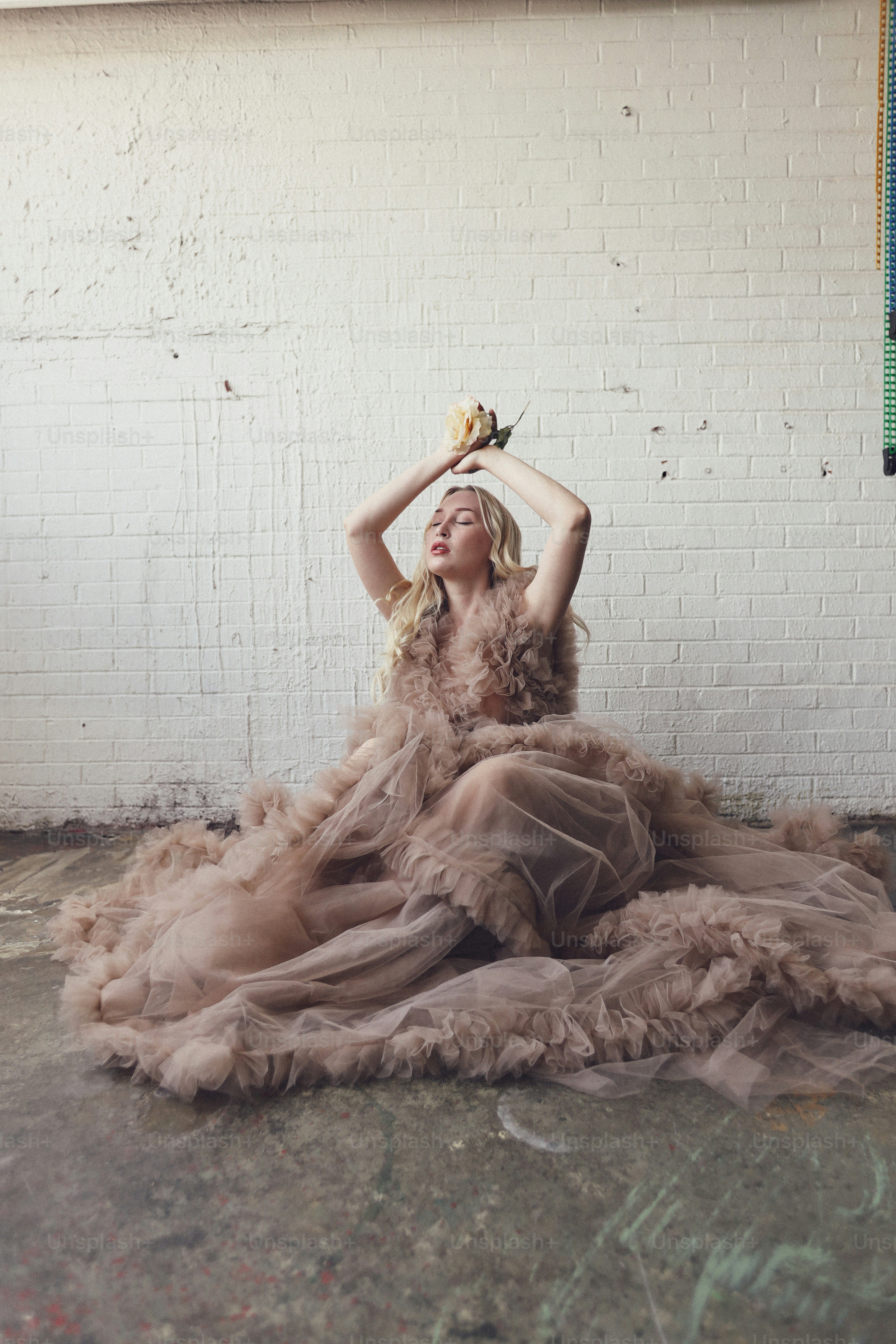 A woman in a dress sitting on the floor photo – Fashion Image on Unsplash