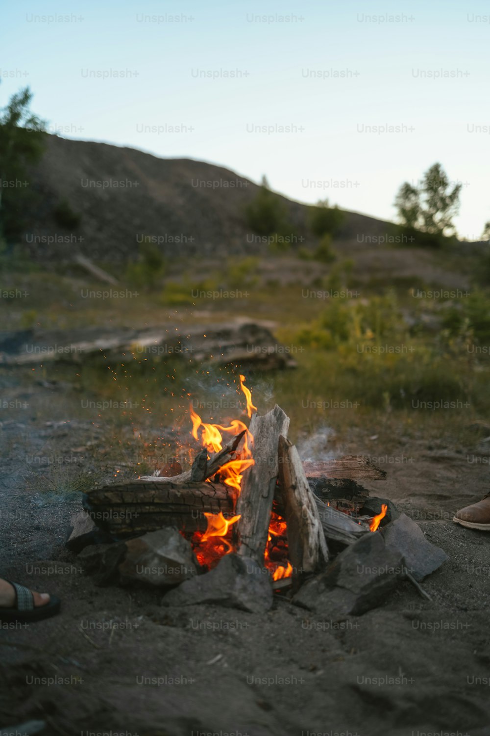 a person sitting in front of a campfire
