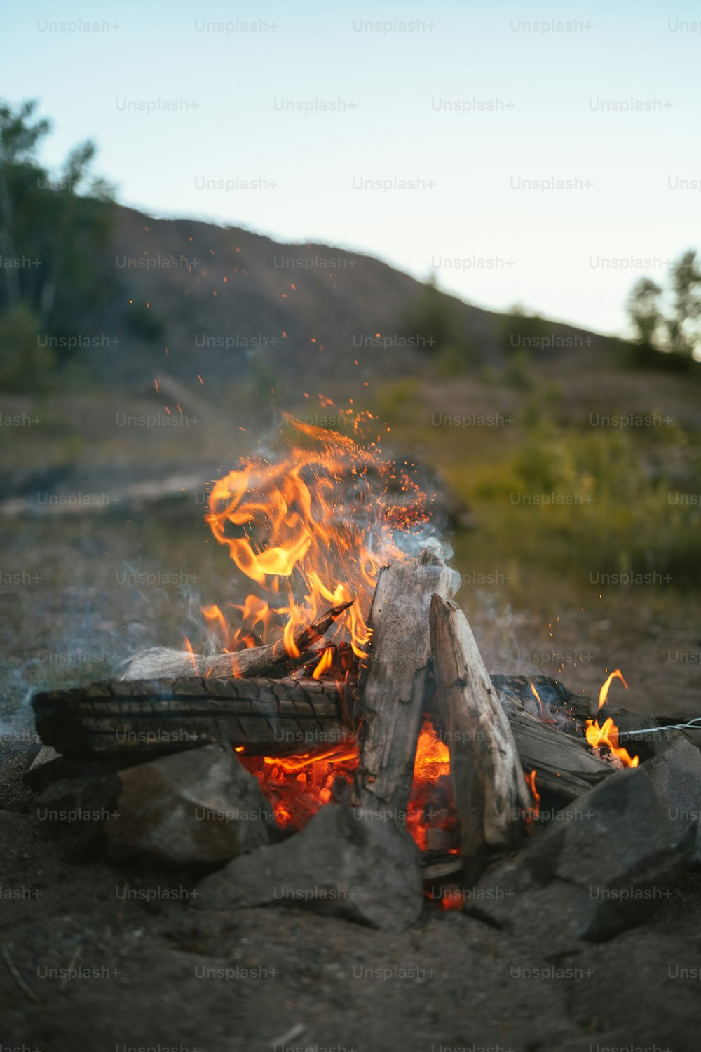 a fire burning in the middle of a field