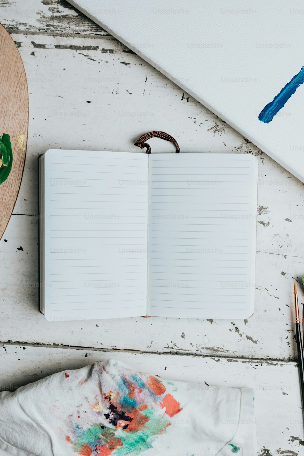 an open notebook sitting on top of a wooden table