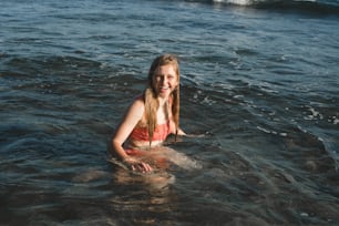 a girl in a red bathing suit in the water