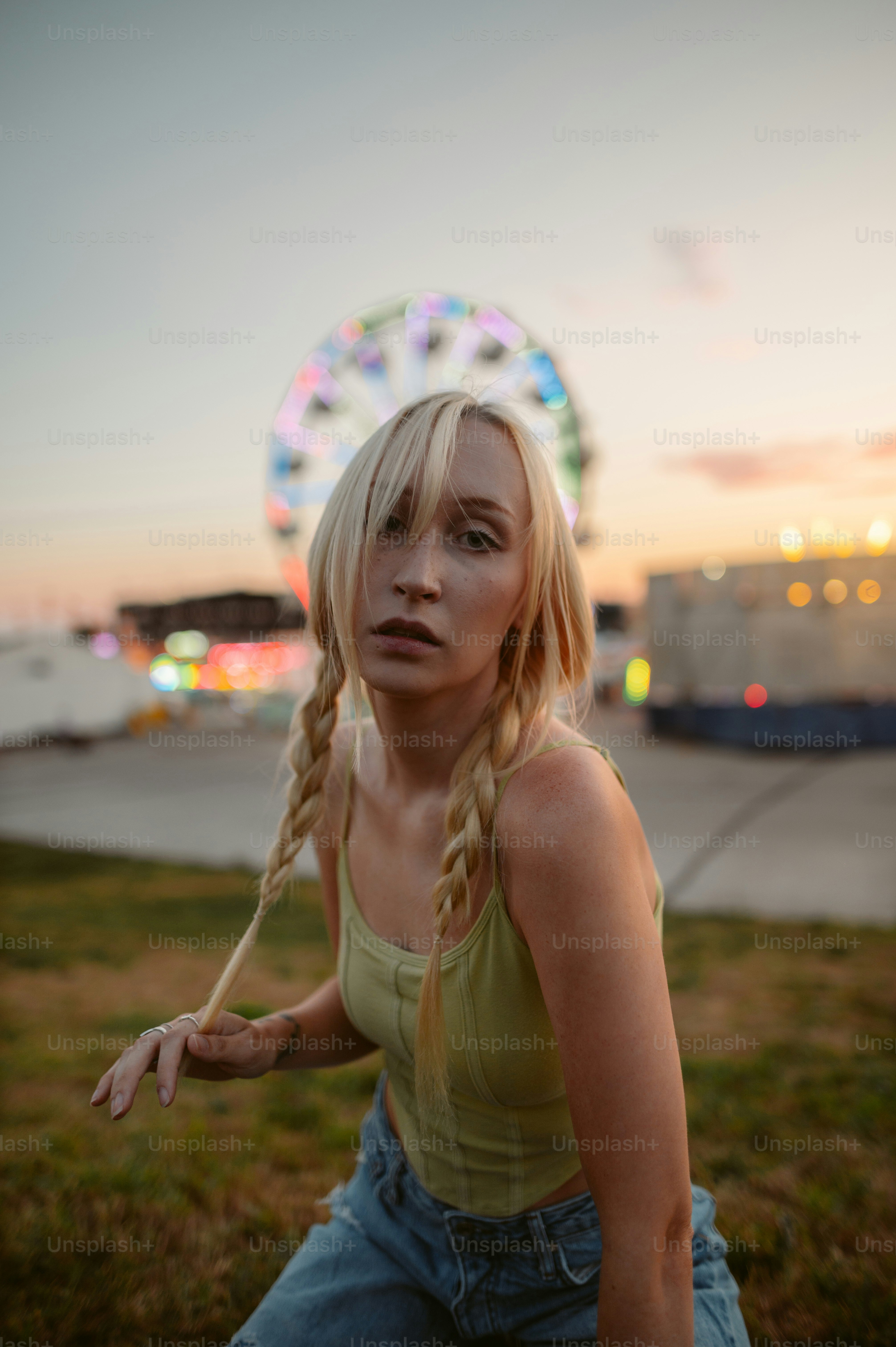 a woman with blonde hair sitting in a field