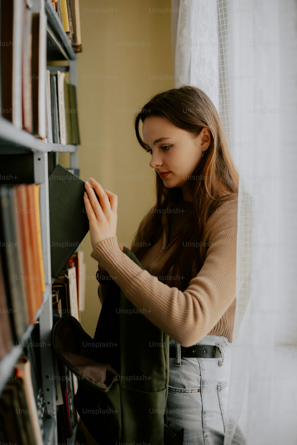 a woman standing in front of a book shelf