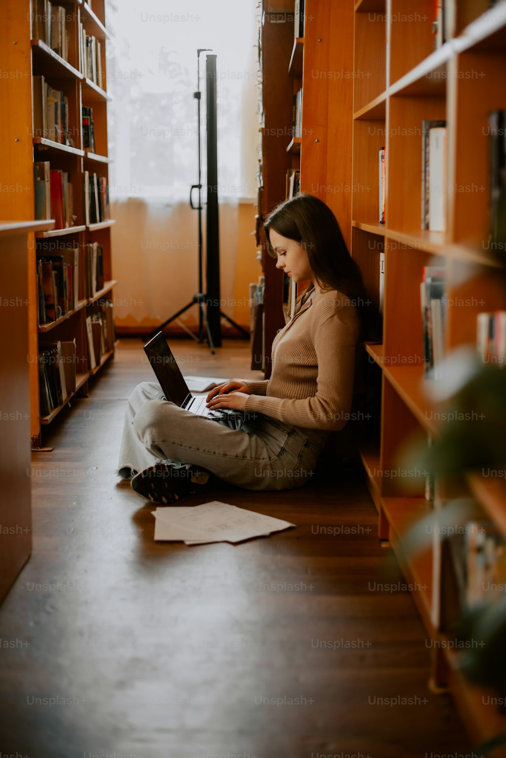 a woman sitting on the floor using a laptop computer