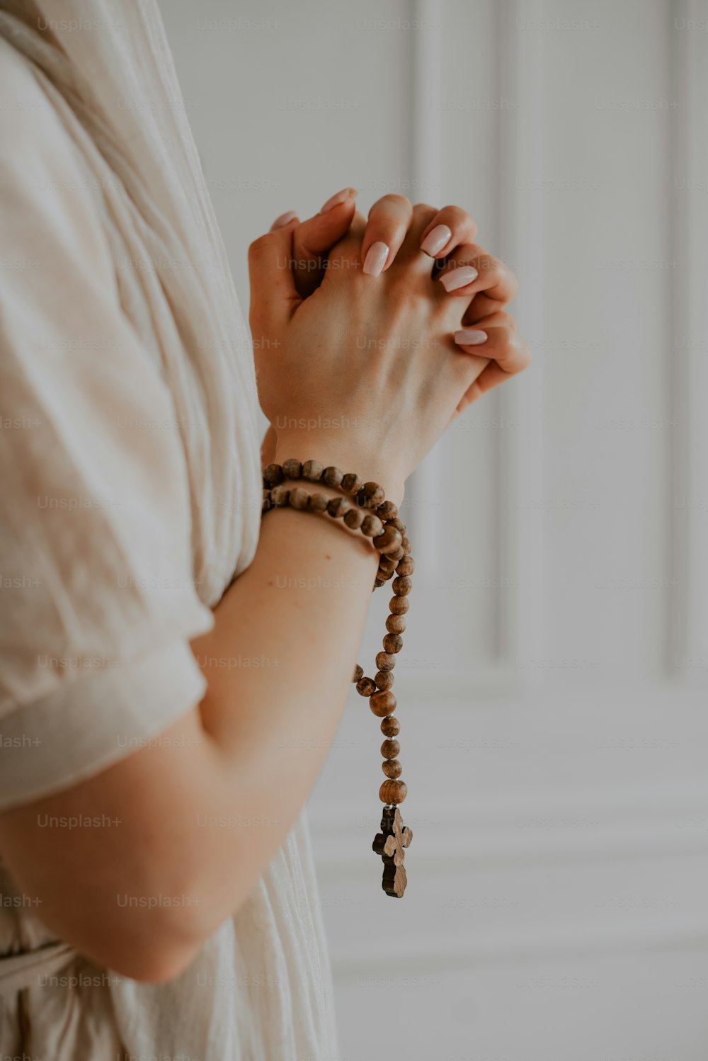 uma mulher usando uma pulseira com uma cruz sobre ela
