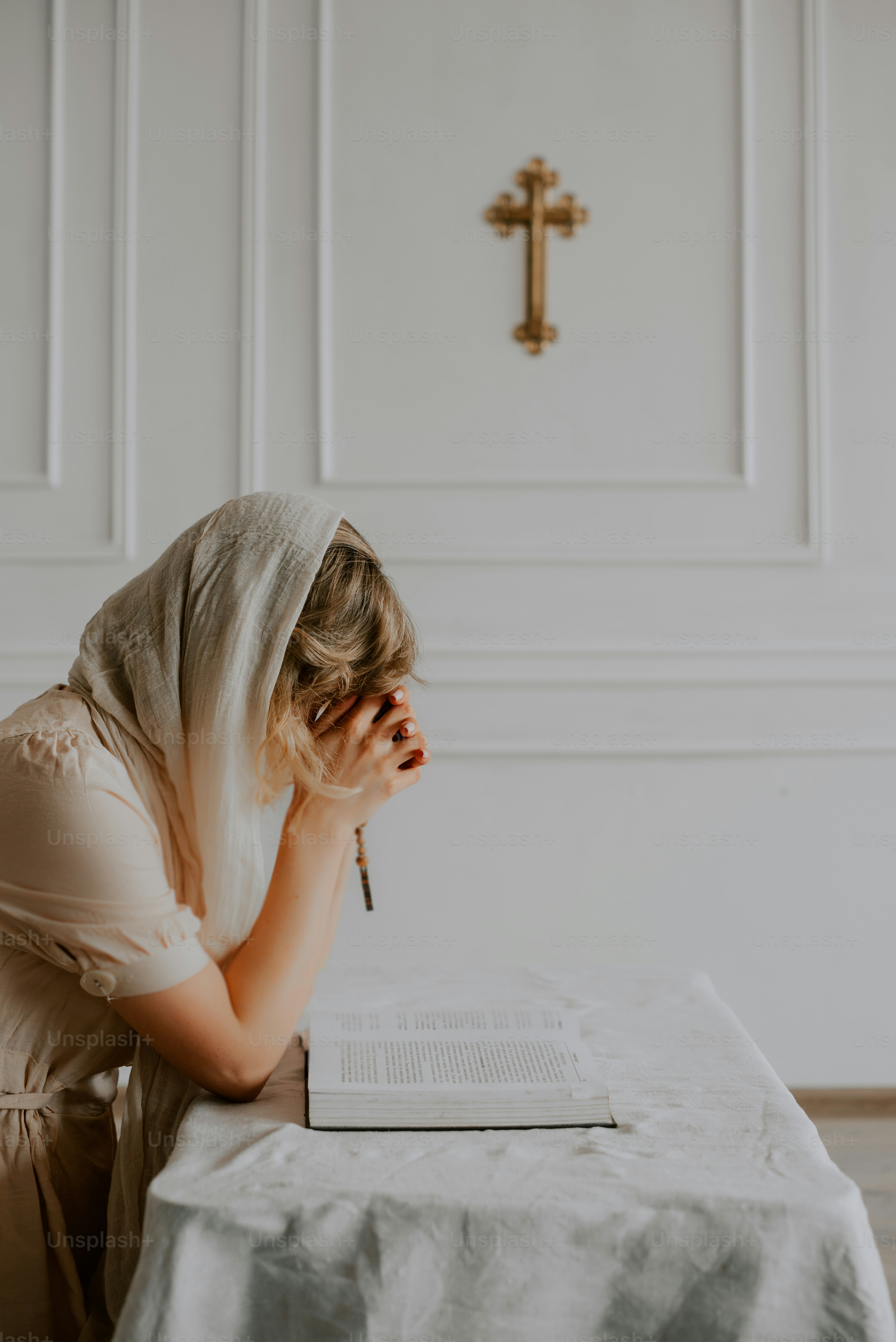 a woman sitting at a table with a pen in her hand