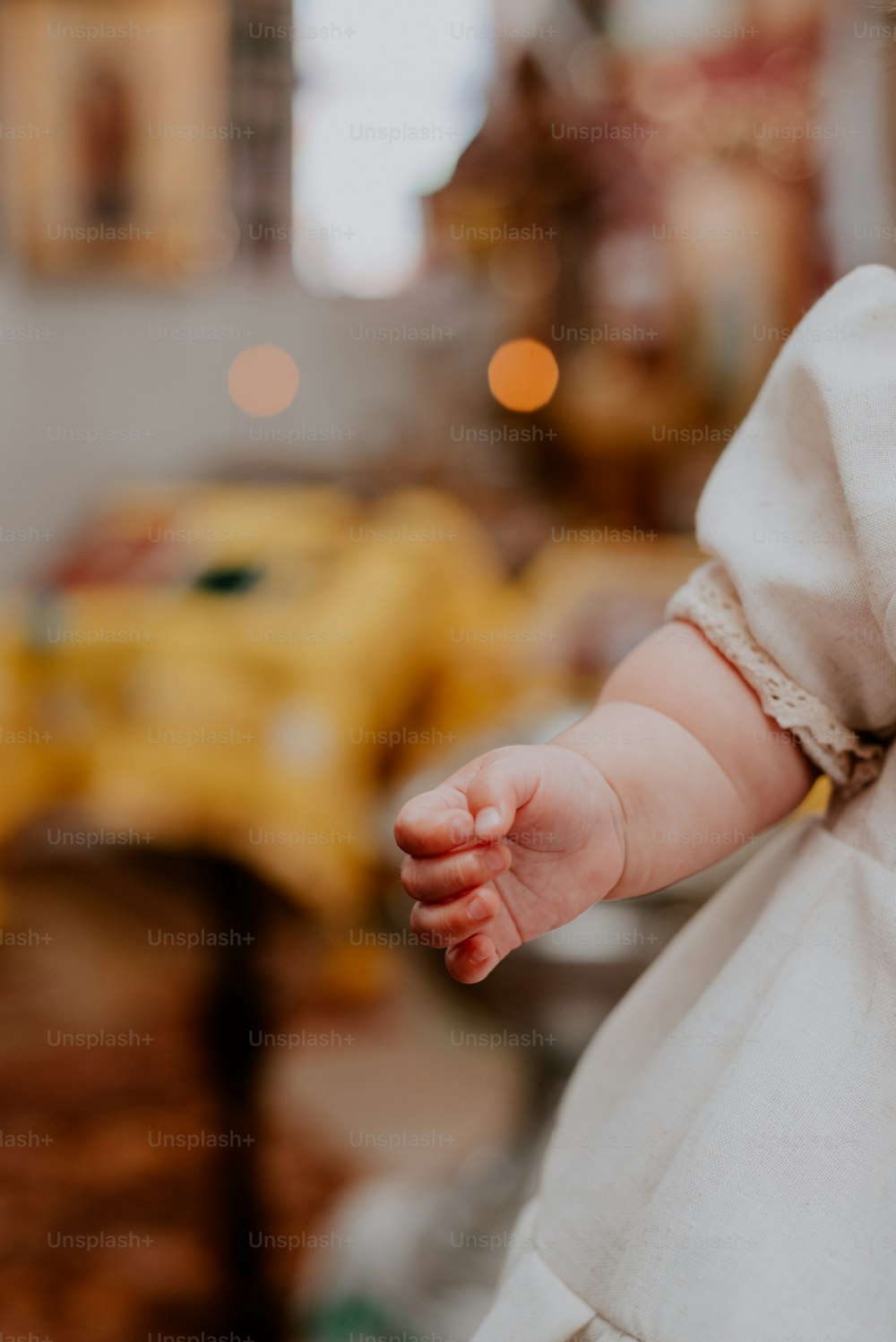 a close up of a baby's hand with a blurry background