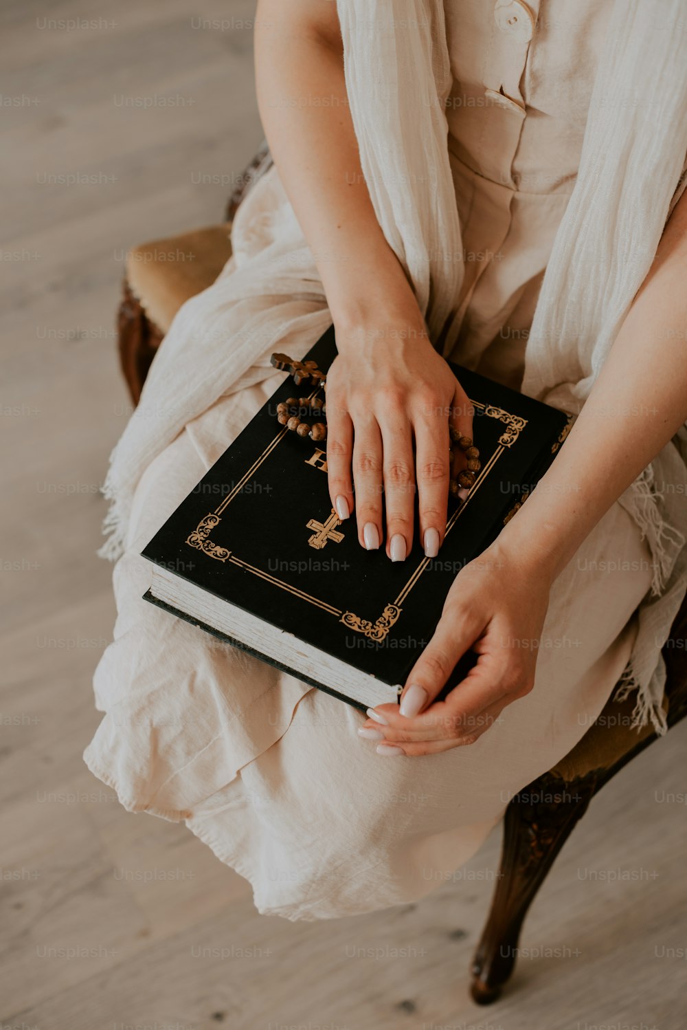 a woman sitting on a chair holding a book