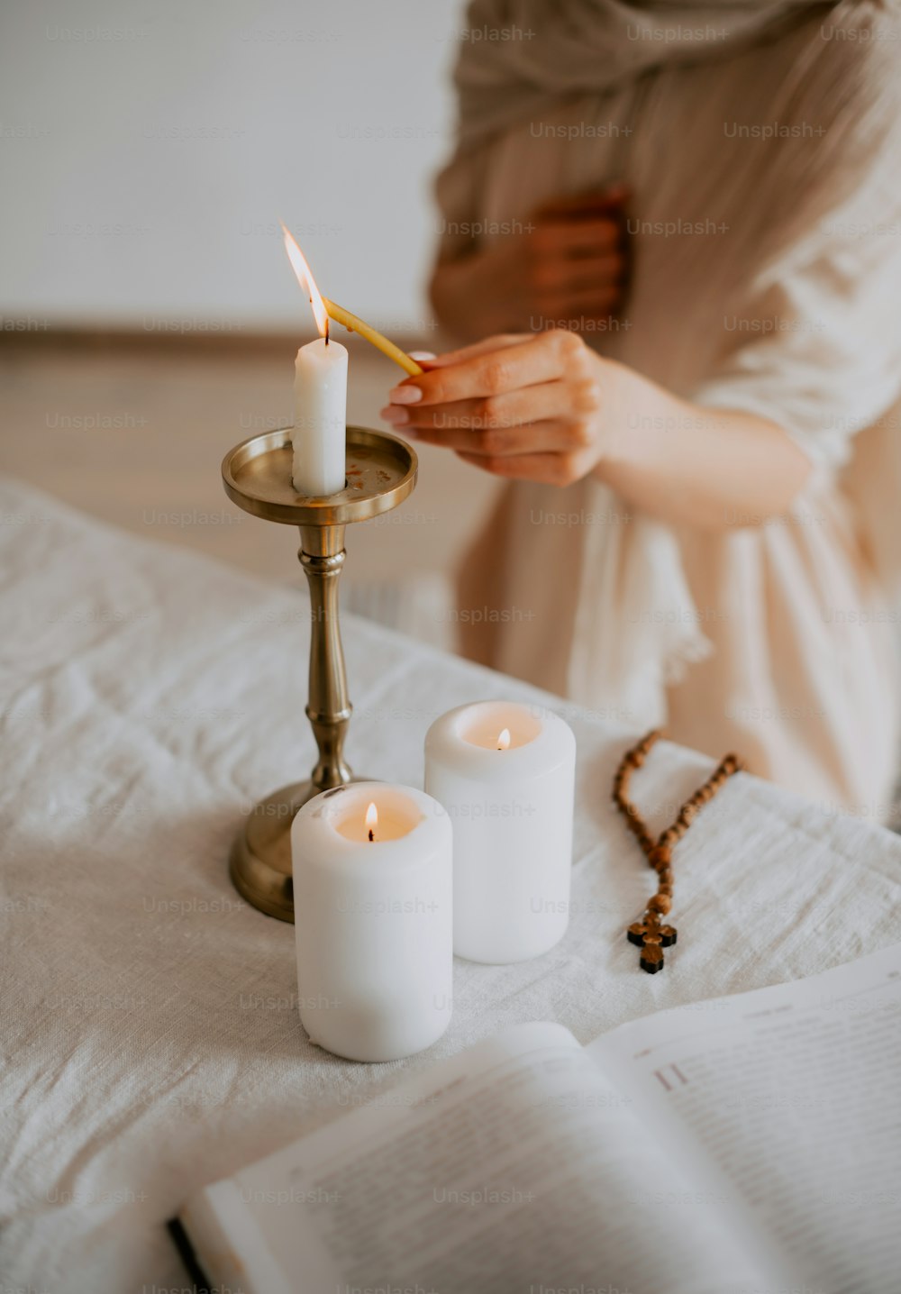 a person lighting a candle on a table