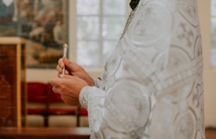 a woman in a white dress holding a cell phone