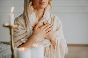 a woman in a shawl holding her hands together