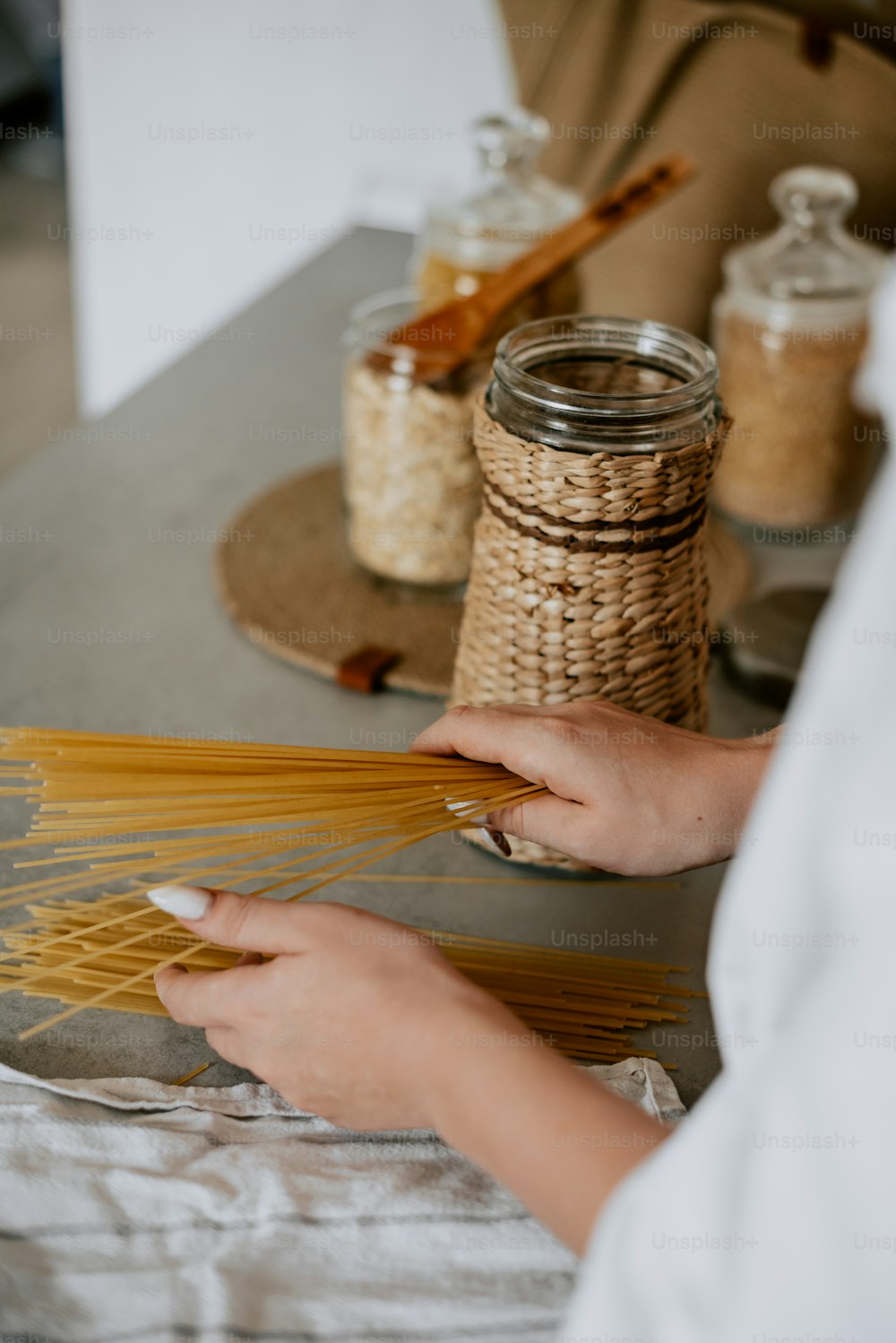 a woman is making pasta on a table
