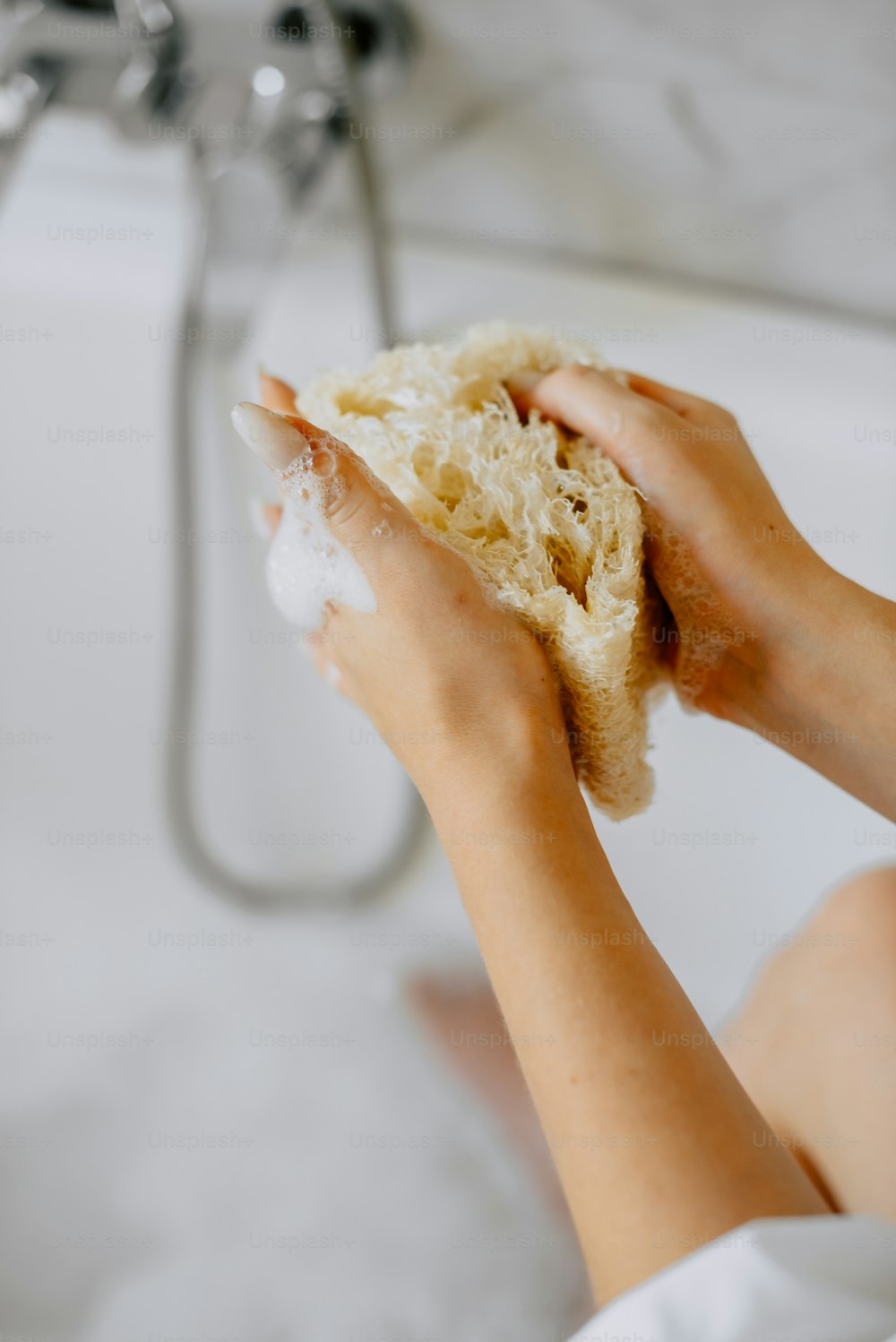 a person is cleaning a bathtub with a rag