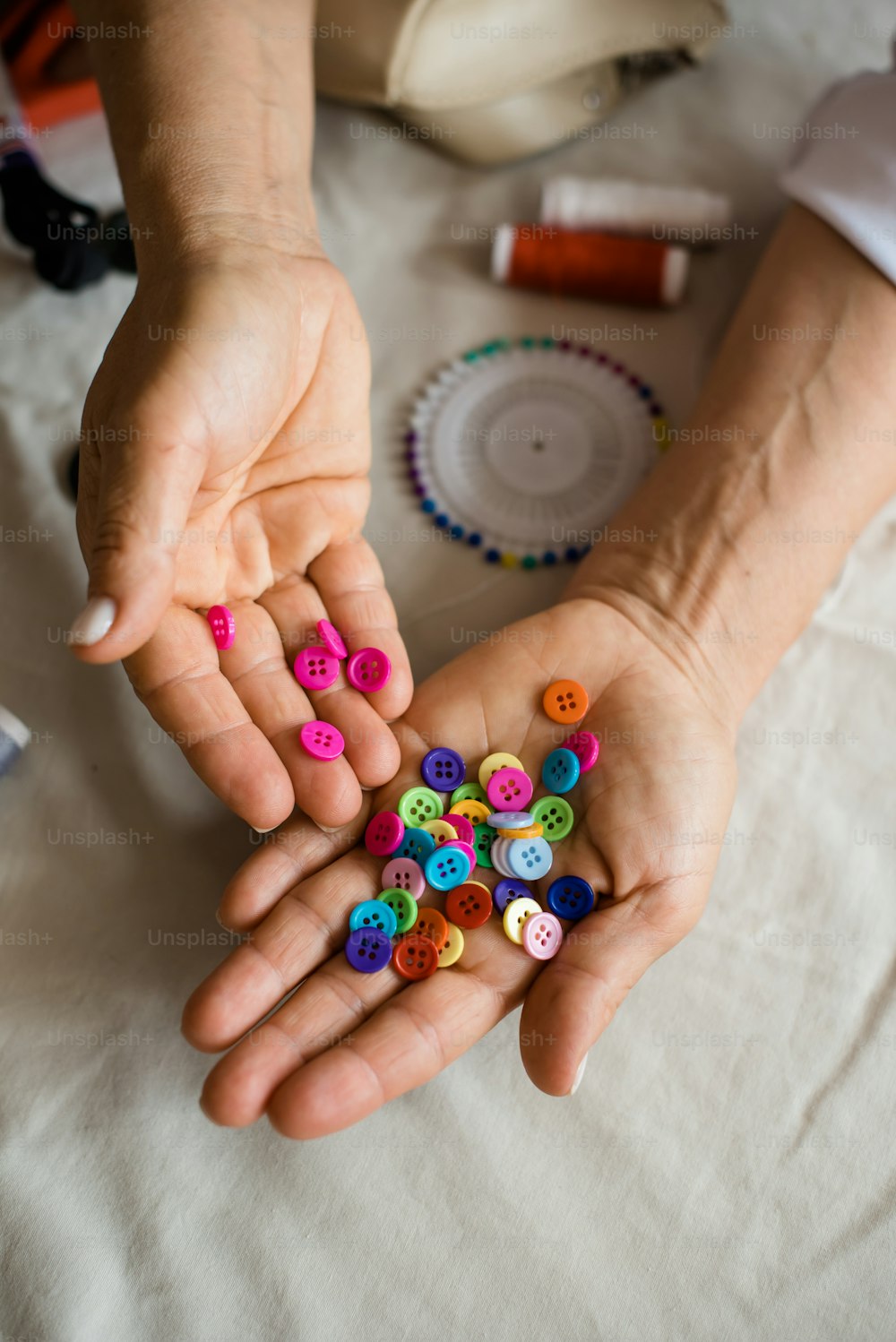 a person holding a bunch of buttons in their hands
